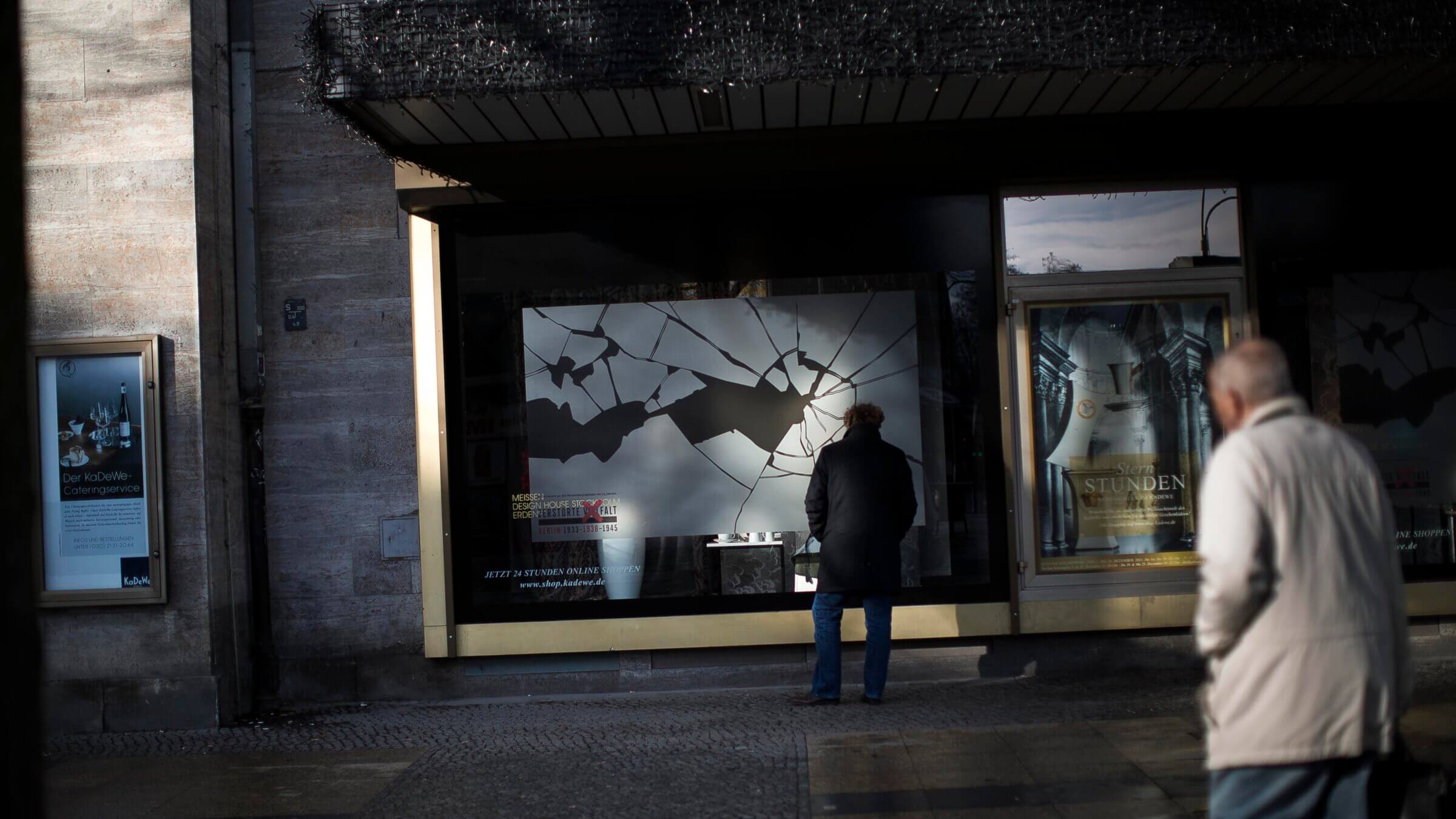 People walk past a Berlin window display commemorating the 75th anniversary of the Kristallnacht pogroms 2013. Germany has won plaudits confronting Nazi crimes, and American officials have turned toward the country for lessons about how to defeat contemporary antisemitism. But some critics sorry that Germany's approach might not be a good fit for the U.S.