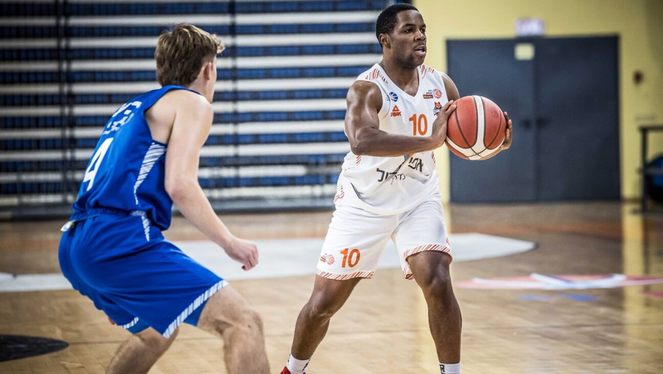 Jared Armstrong, right, playing professional basketball in Israel. (Courtesy of Jared Armstrong)