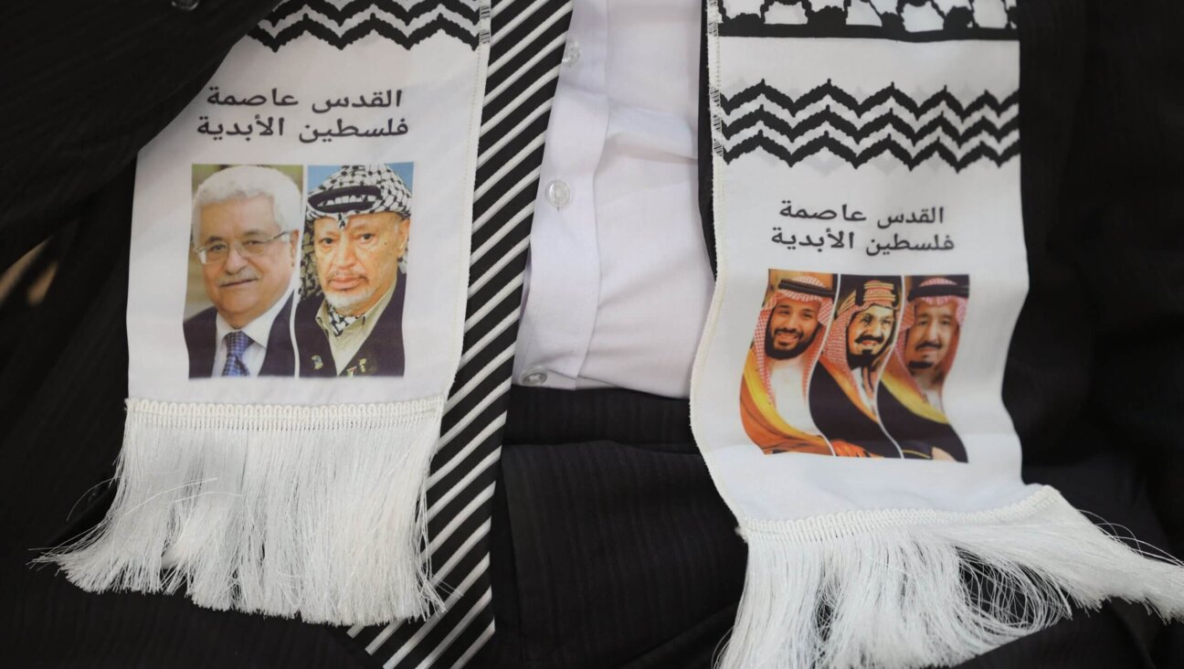 Palestinian ambassador to Saudi Arabia Bassem al-Agha wears a scarf depicting Palestinian and Saudi leaders, during a condolences reception for slain Al-Jazeera reporter Shireen Abu Akleh at the Palestinian embassy in the Saudi capital Riyadh on May 17, 2022. The scarf reads in Arabic "Jerusalem is the capital of Palestine" and depicts (L to R) Palestinian president Mahmud Abbas and his predecessor Yasser Arafat, Saudi Arabia's Crown Prince Mohamed bin Salman bin Abdulaziz al-Saud, the kingdom's founding King Abdulaziz ibn Saud, and current leader, King Salman bin Abdulaziz. 