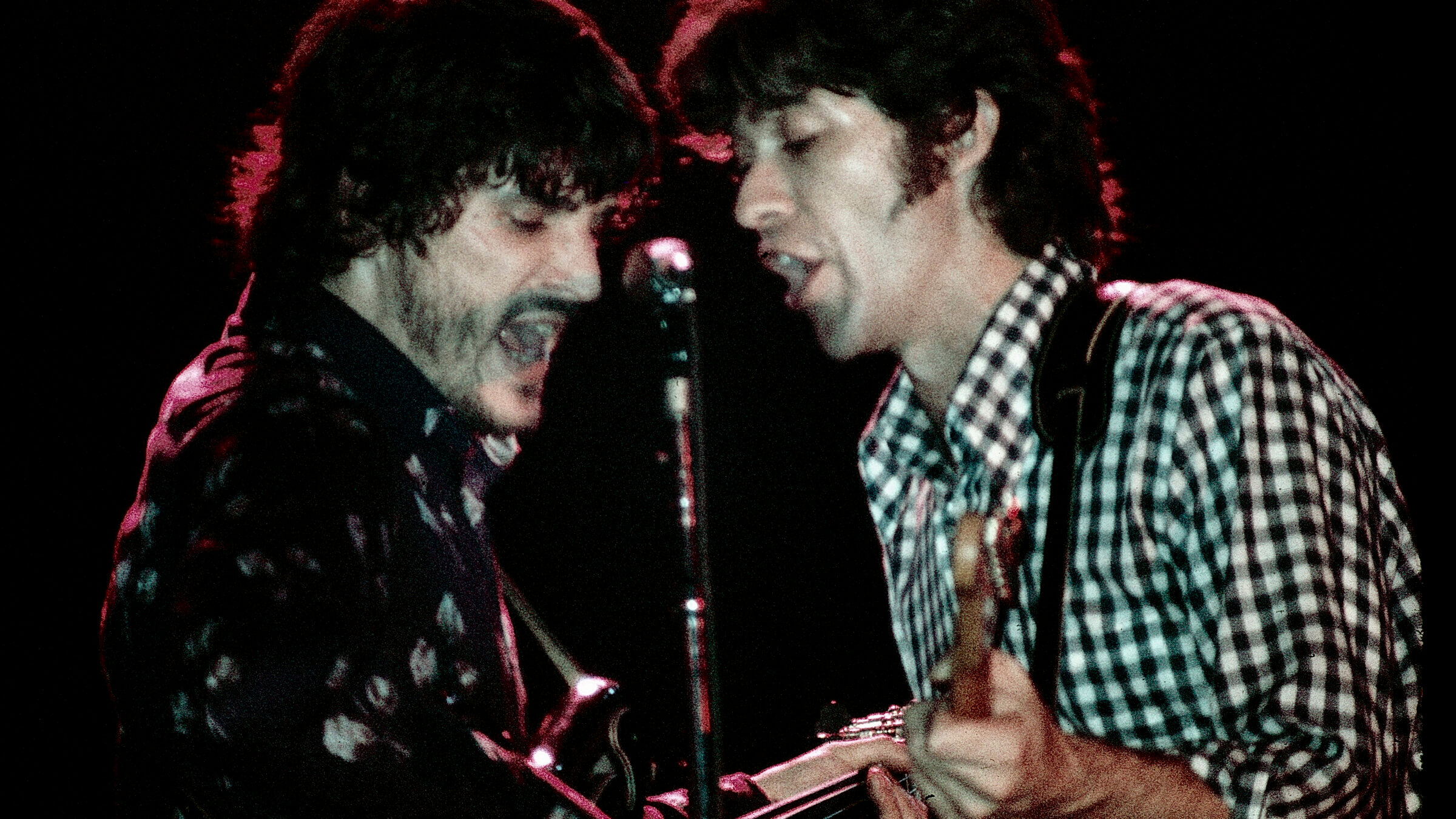 Rick Danko and Robbie Robertson perform together as part of The Band in 1974.