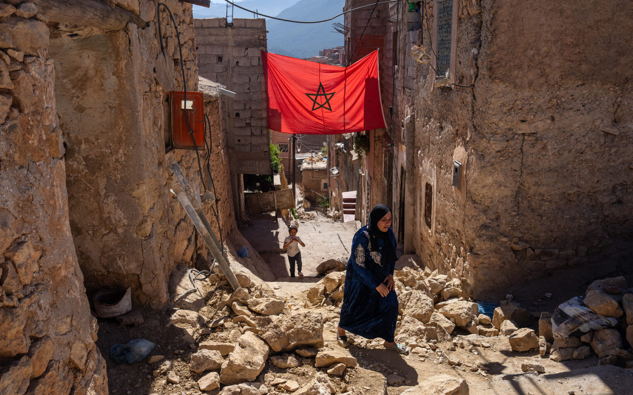 A woman walks past the rubble of damaged buildings following the Sept. 8 earthquake in Moulay Brahim, Morocco. (Carl Court/Getty Images)