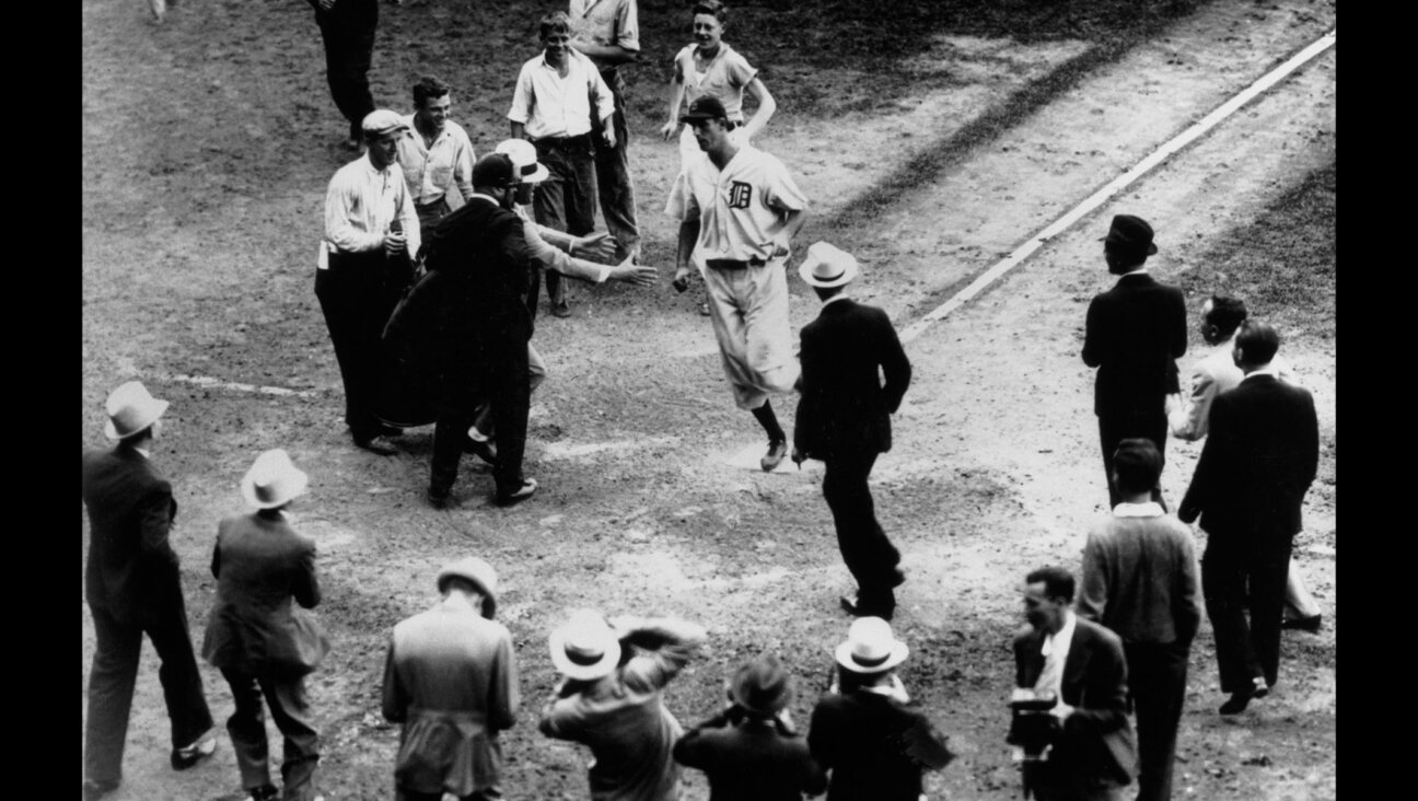 Hank Greenberg scores after hitting a home run to give the Detroit Tigers a 2-1 victory over the Boston Red Sox, Sept. 10, 1934. (UPI/Bettmann Archive/Getty Images)