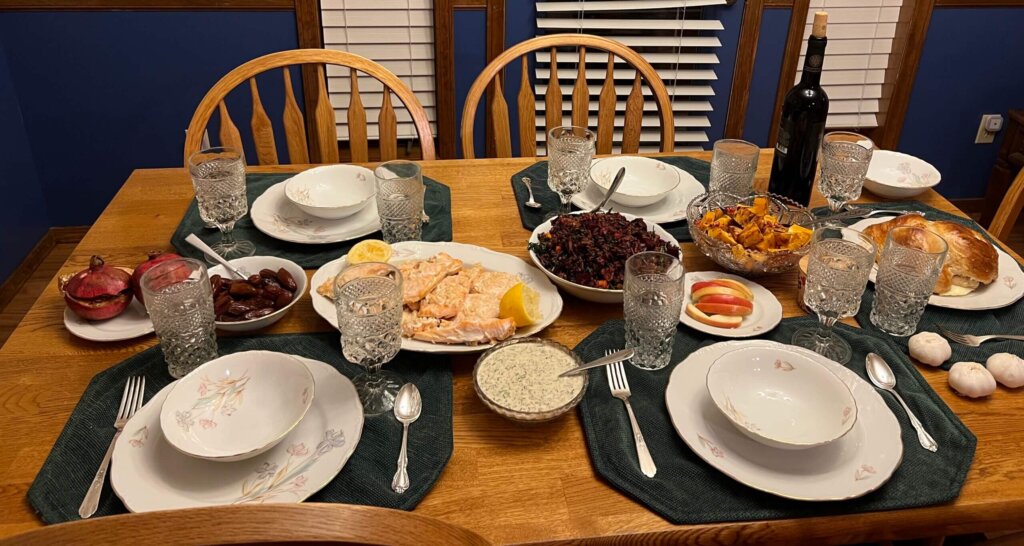 A simple pescatarian Rosh Hashanah dinner. Here, garlic "heads" stand in for those of fish or a ram.