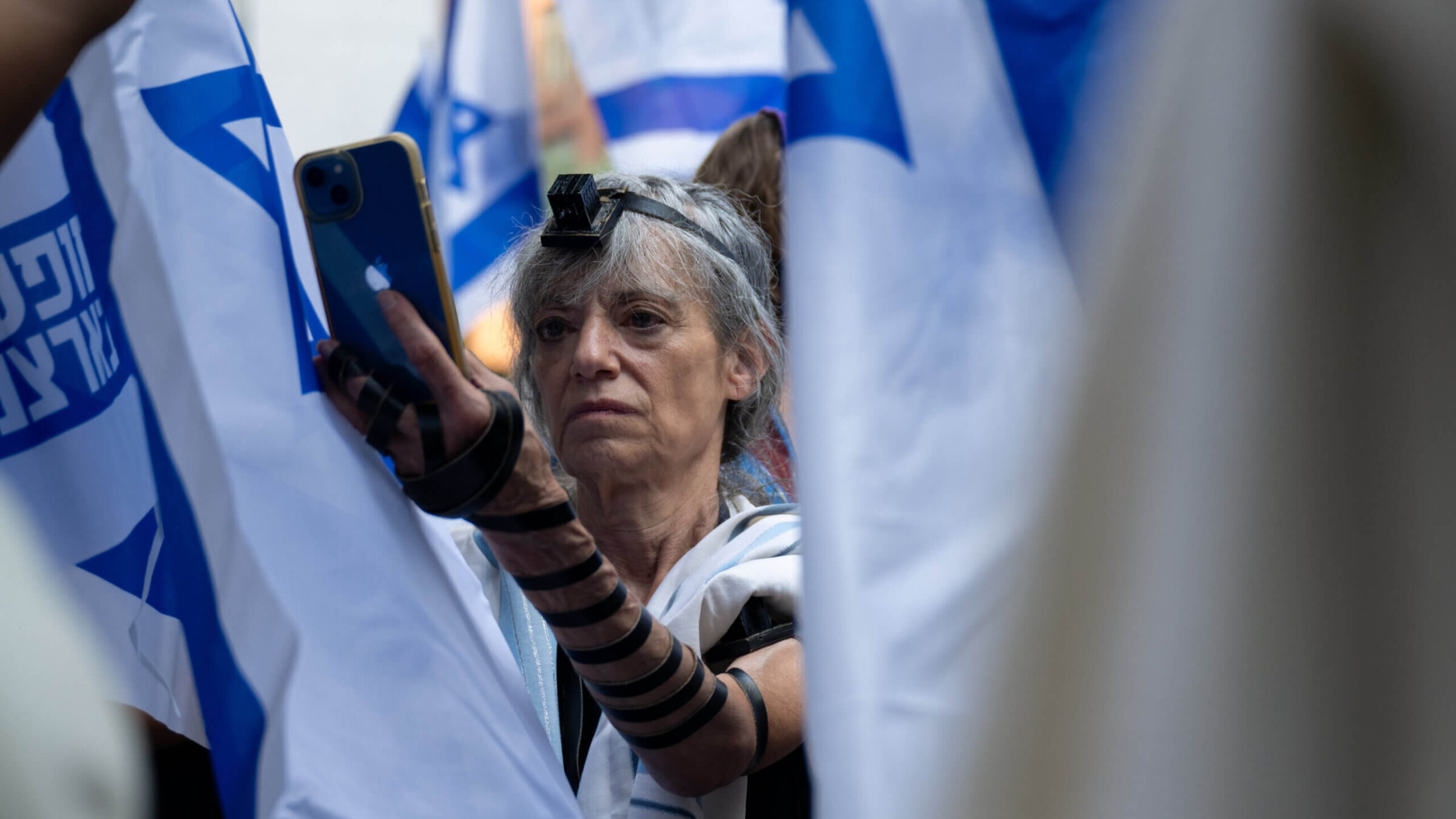 A protestor wears tefillin during the service portion of a Praying for Israeli Democracy rally on the Jewish holiday of Tisha B’ Av outside the Israeli Consulate in New York on July 27, 2023 in New York City. 