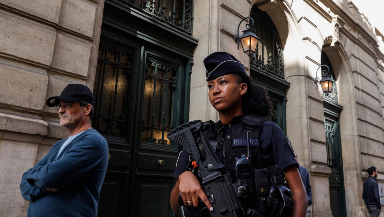 A French police officer patrols outside the Tournelles Synagogue in Paris after increased security measures were put in place at Jewish temples and schools, Oct. 8, 2023. (Geoffroy van der Hasselt/AFP via Getty Images)