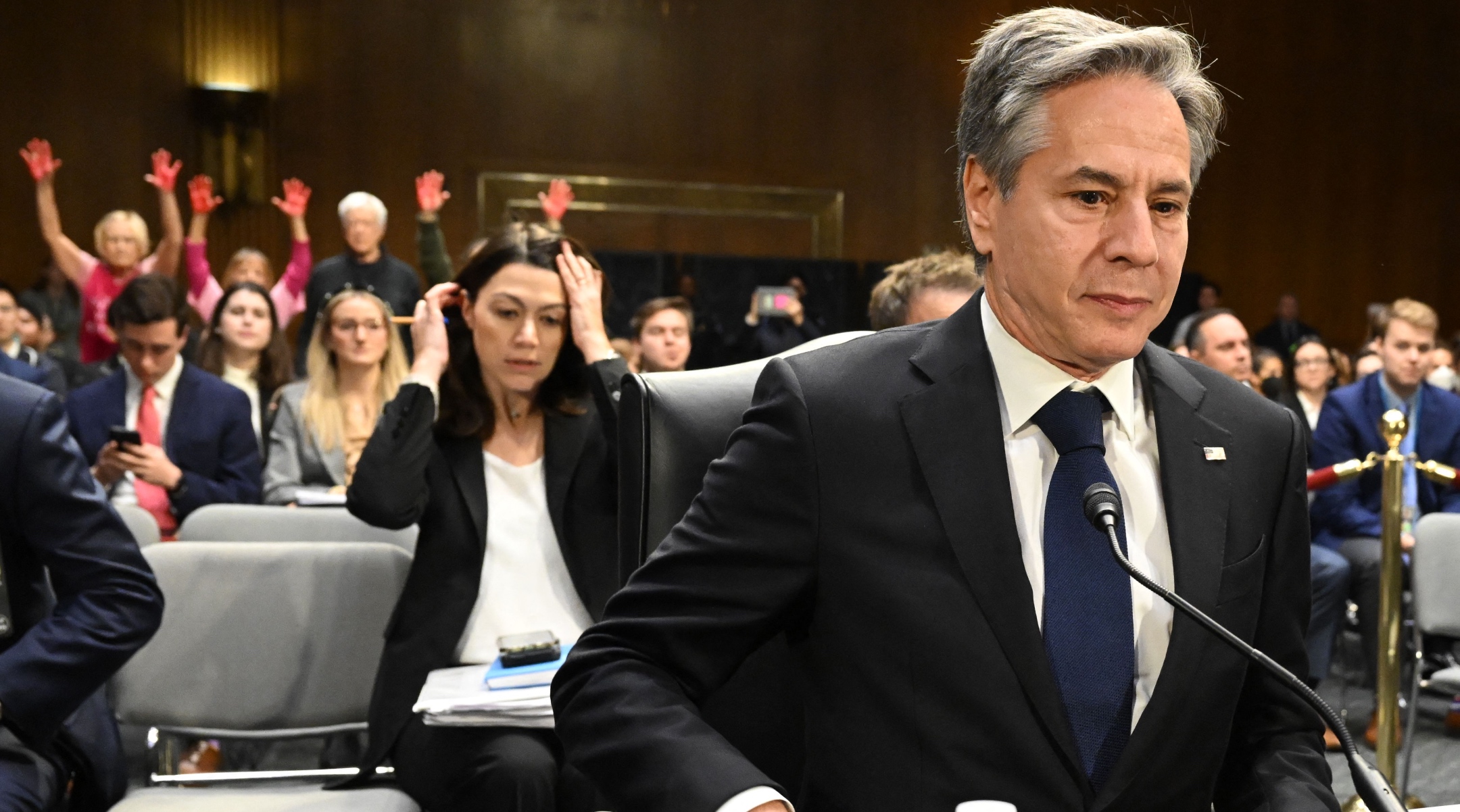 U.S. Secretary of State Antony Blinken looks on as protestors hold their hands in the air during a Senate Appropriations Committee hearing to examine the national security supplemental request, on Capitol Hill, Oct. 31, 2023. (Saul Loeb/AFP via Getty Images)