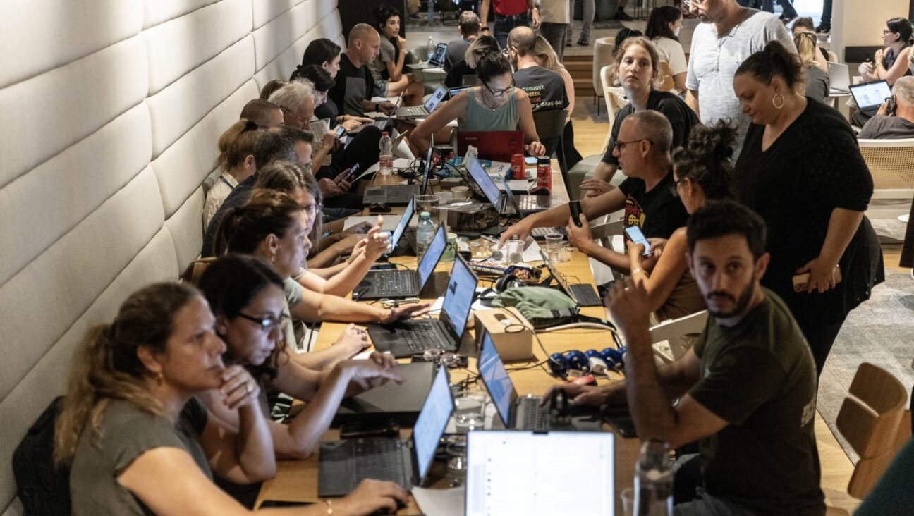 Israeli volunteers work to collect and distribute donations and food for citizens in the country's south at an emergency center in Tel Aviv, October 2023.