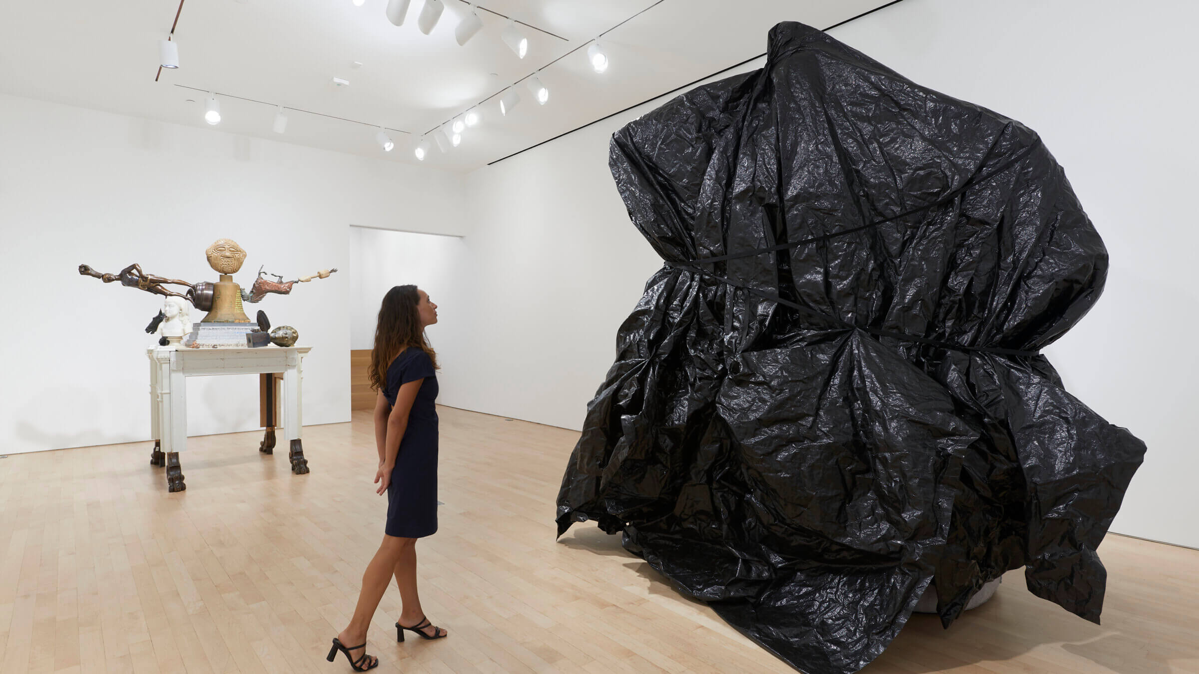 A gallerygoer contemplates Michael Rakowitz's <i>Behemoth</i> while his <i>American Golem</i> keeps watch.