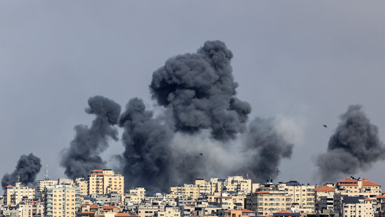 Smoke rises over Gaza City on Oct. 7, 2023 during Israeli air strike. Palestinian militants have begun a "war" against Israel, the country's defense minister said on October 7