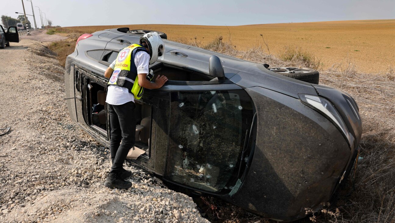 A member of Magen David Adom emergency medical services checks a car near the southern Israeli city of Sderot that was shot at during the Oct. 7 attacks by Hamas. Millions of dollars in donations from U.S. corporations and philanthropies are going to humanitarian organizations like Magen David Adom. 