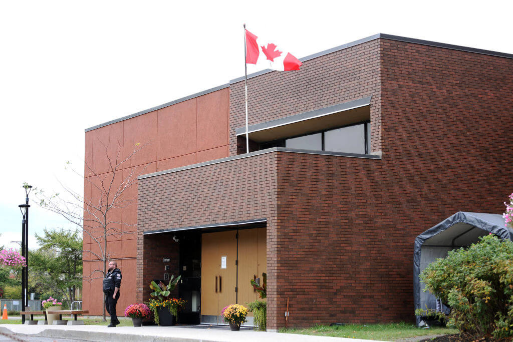 A security guard stands outside the front door of Congregation Machzikei Hadas, an Orthodox synagogue in Ottawa, Canada, on October 8, 2023.