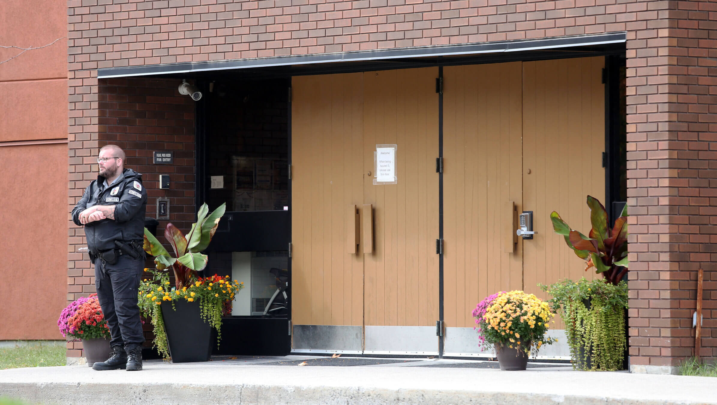 A security guard stands outside the front door of Machzikei Hadas Orthodox synagogue on Oct. 8, 2023, in Ottawa after the Palestinian militant group Hamas launched an assault on Israel.