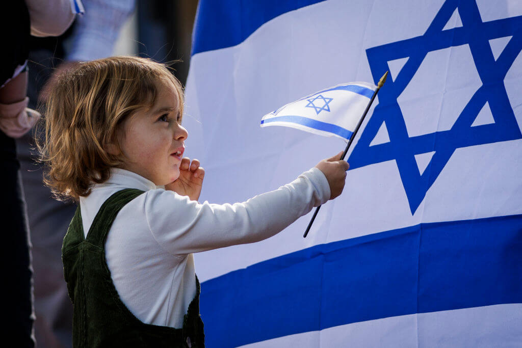 A child waves an Israeli flag during a rally outside of the Israeli embassy on Oct. 8, 2023 in Washington, DC. 