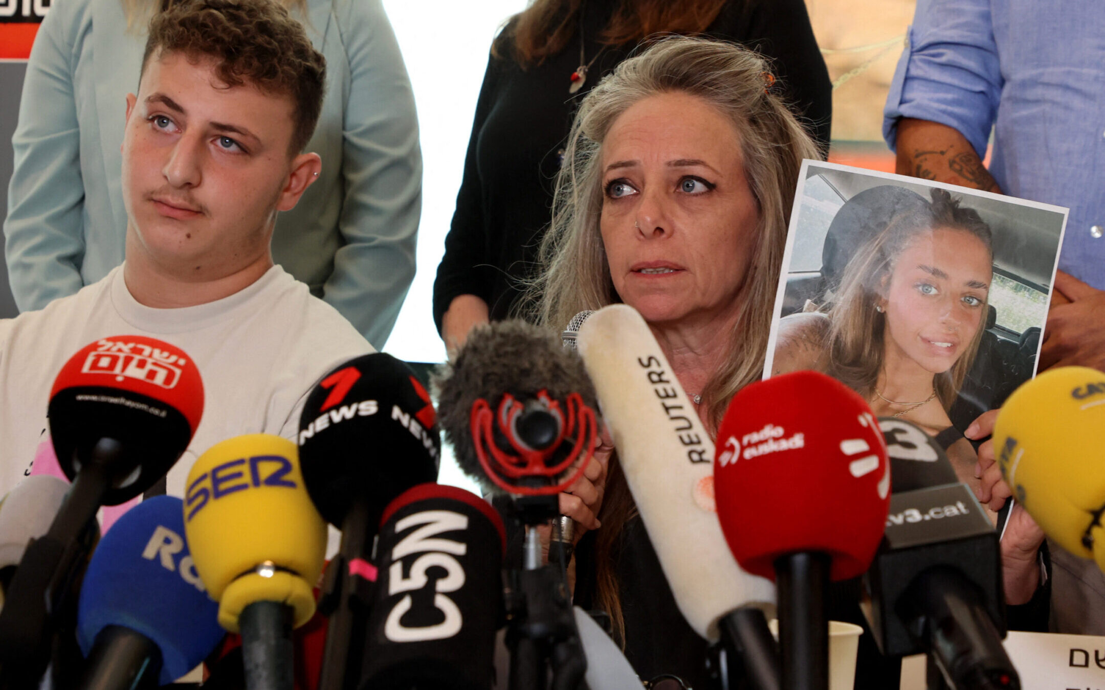 Keren Shem, the mother of French-Israeli woman Mia Shem who is held hostage by Hamas in Gaza, holds a photograph of her daughter as she speaks to the press in Tel Aviv, Oct. 17, 2023. (Gil Cohen Magen/AFP via Getty Images)