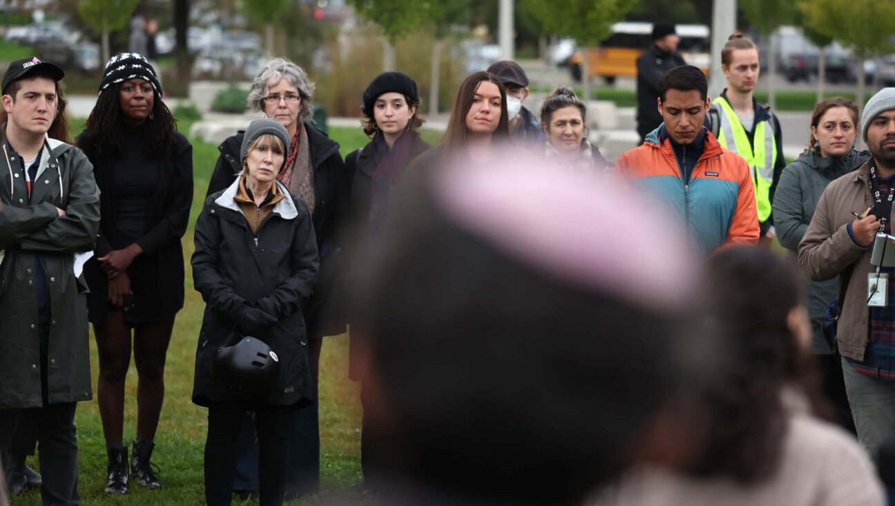 Jews gather at a Chicago park to recite the kaddish and light candles to mourn the Palestinians and Israelis killed during recent fighting.