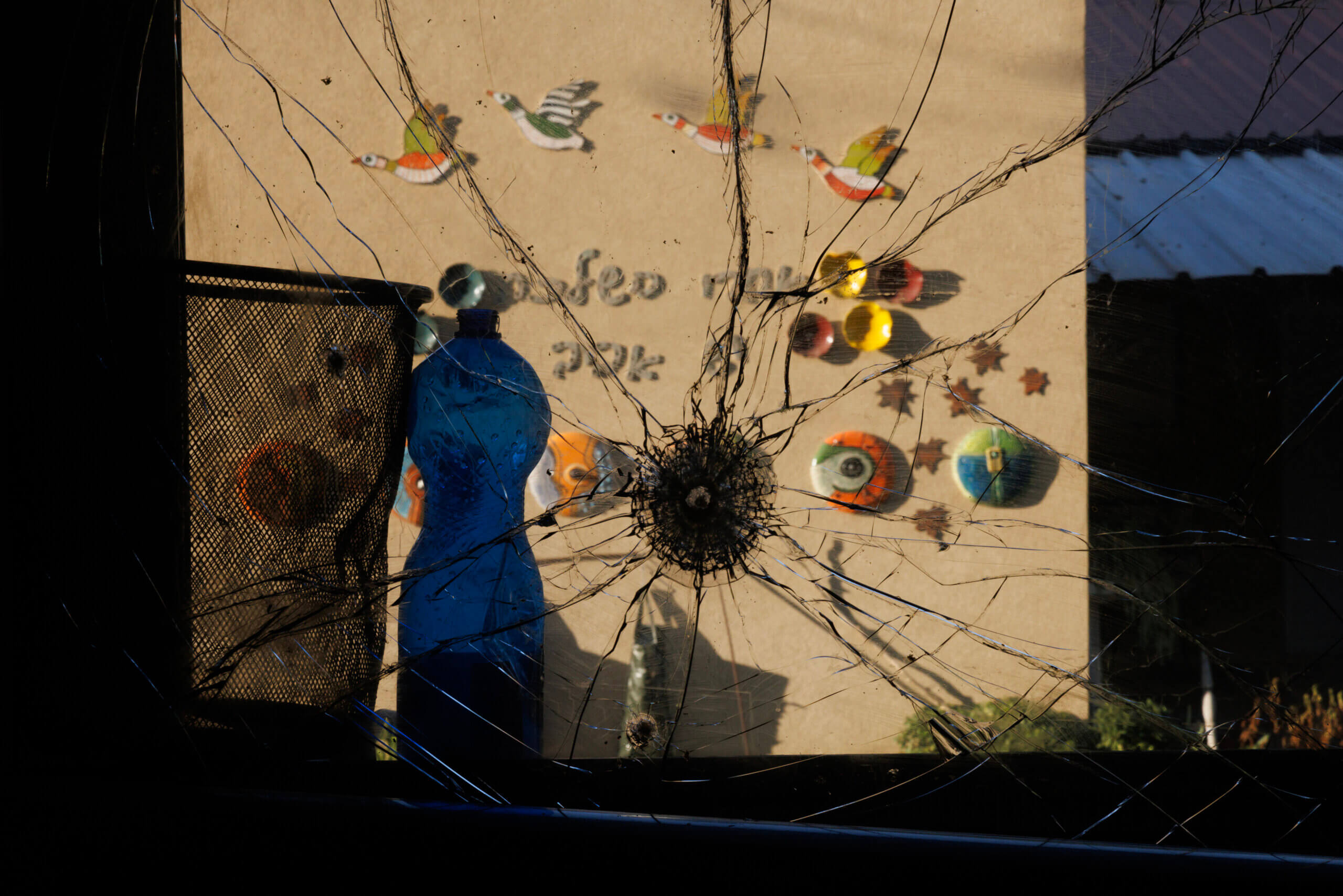  a bullet hole is seen in the window of a bedroom at Kibbutz Holit.