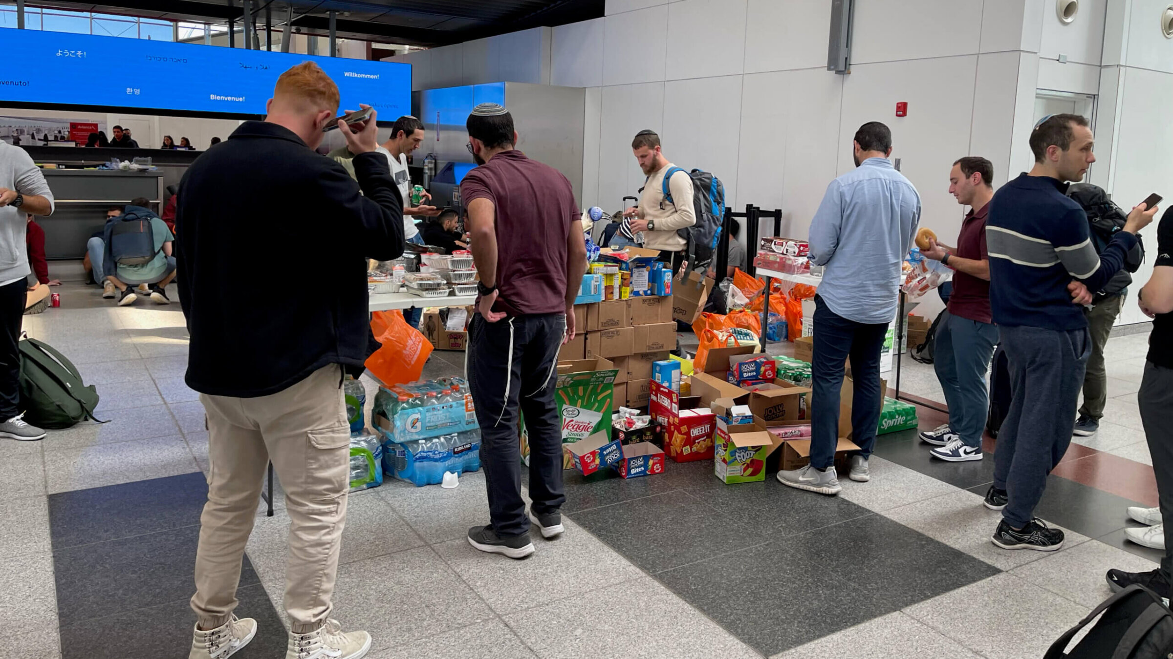 Volunteers from Brooklyn set up tables laden with snacks, flashlights and other supplies for Israeli soldiers and others headed to Israel on Monday at John F. Kennedy International Airport in New York, two days after Hamas launched the most serious attack on Israel in decades.