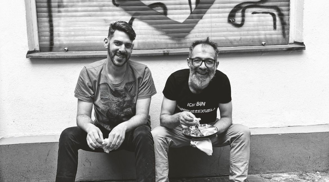 Oz Ben David, right, wears a shirt that translates to “I am a hummussexual.” He and Jalil Dabrit opened Kanaan in 2015. (Elisabeth Patrikiou)