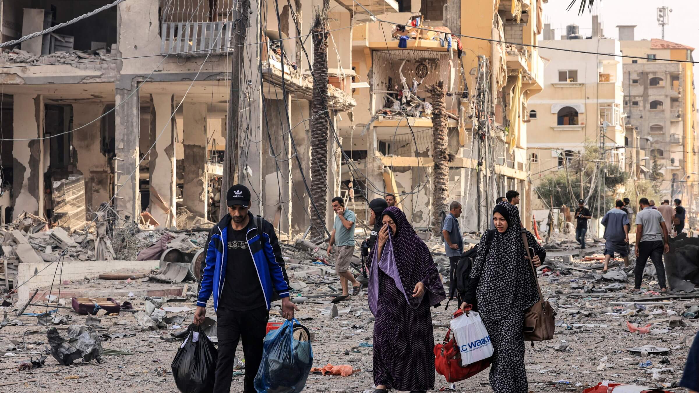 Palestinians leave al-Karama neighbourhood in Gaza City to safer areas on Oct. 11