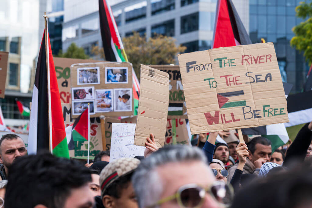 A handmade sign bearing the slogan, "From the river to the sea," is carried by demonstrators Oct. 22 in Brussels, Belgium. 