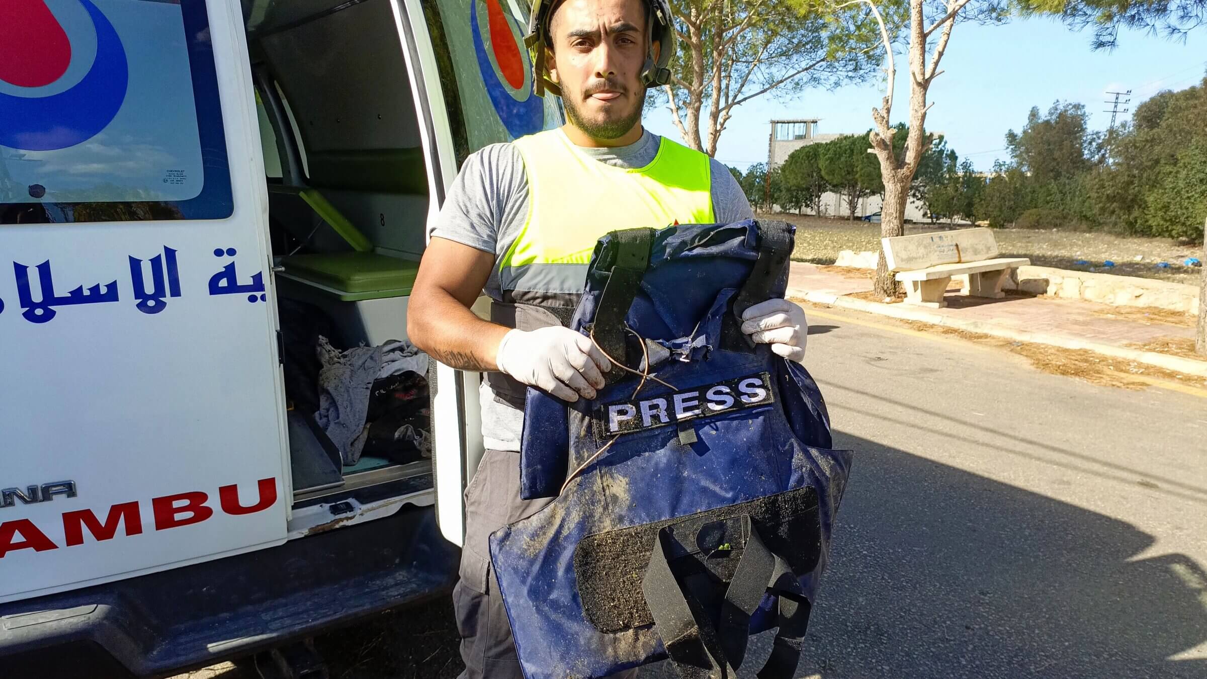 A Lebanese Hezbollah rescuer holds a bulletproof vest that belonged to one of the Al Mayadeen journalists killed in an Israeli bombardment of Tair Harfa, Lebanon, on Nov. 21, 2023. 