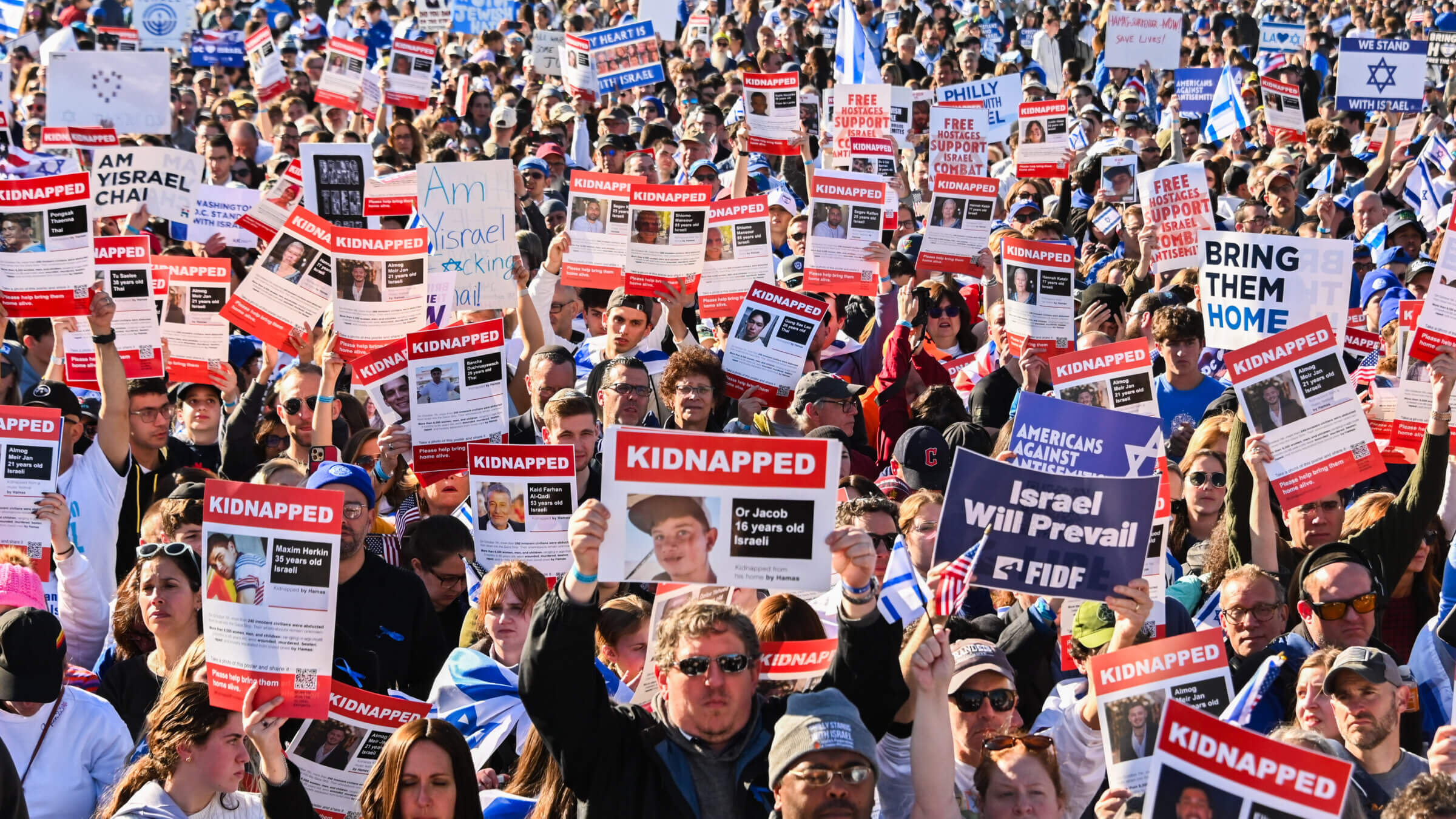 Participants hold up posters of hostages at the March for Israel Nov. 14.