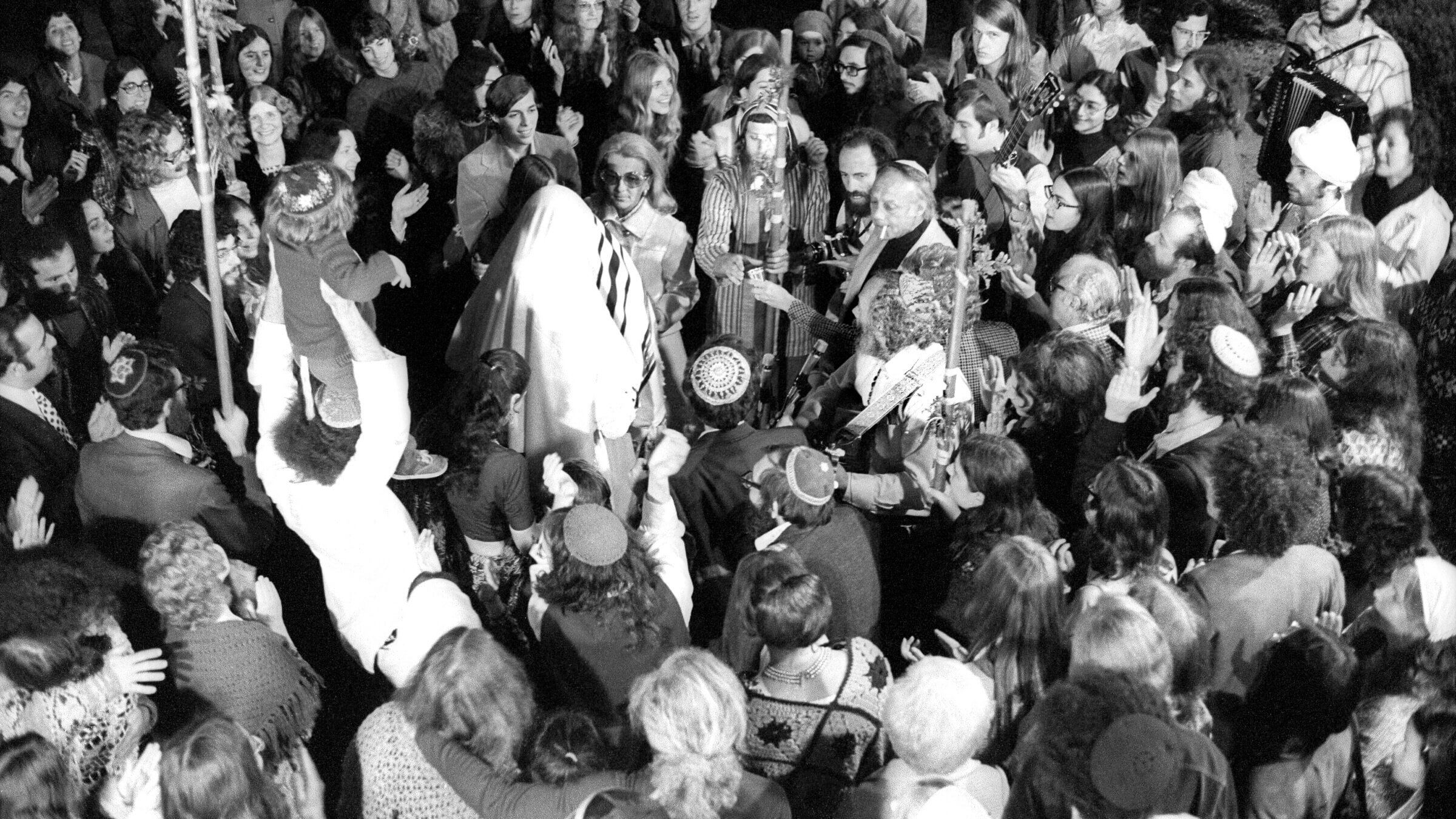 The anthem was composed by Shlomo Carlebach, the so-called 'singing rabbi,' seen here at a wedding in 1973. 