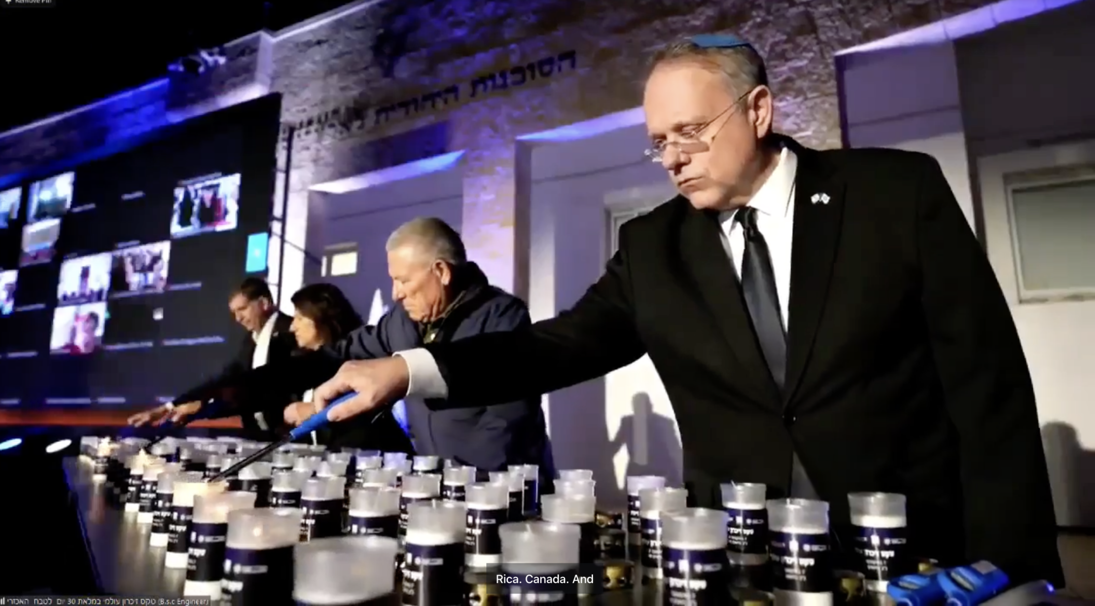 Participants in a ceremony in Jerusalem tied to shloshim, the 30-day mark after a Jewish death, light memorial candles on Sunday, Nov. 5, 2023. (Screenshot)