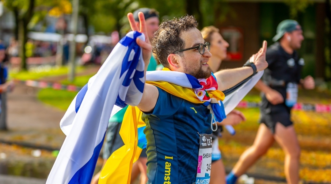 Syrian immigrant Shevan ran the Amsterdam Marathon with Israeli, Palestinian and Ukrainian flags. (Courtesy of Shevan)