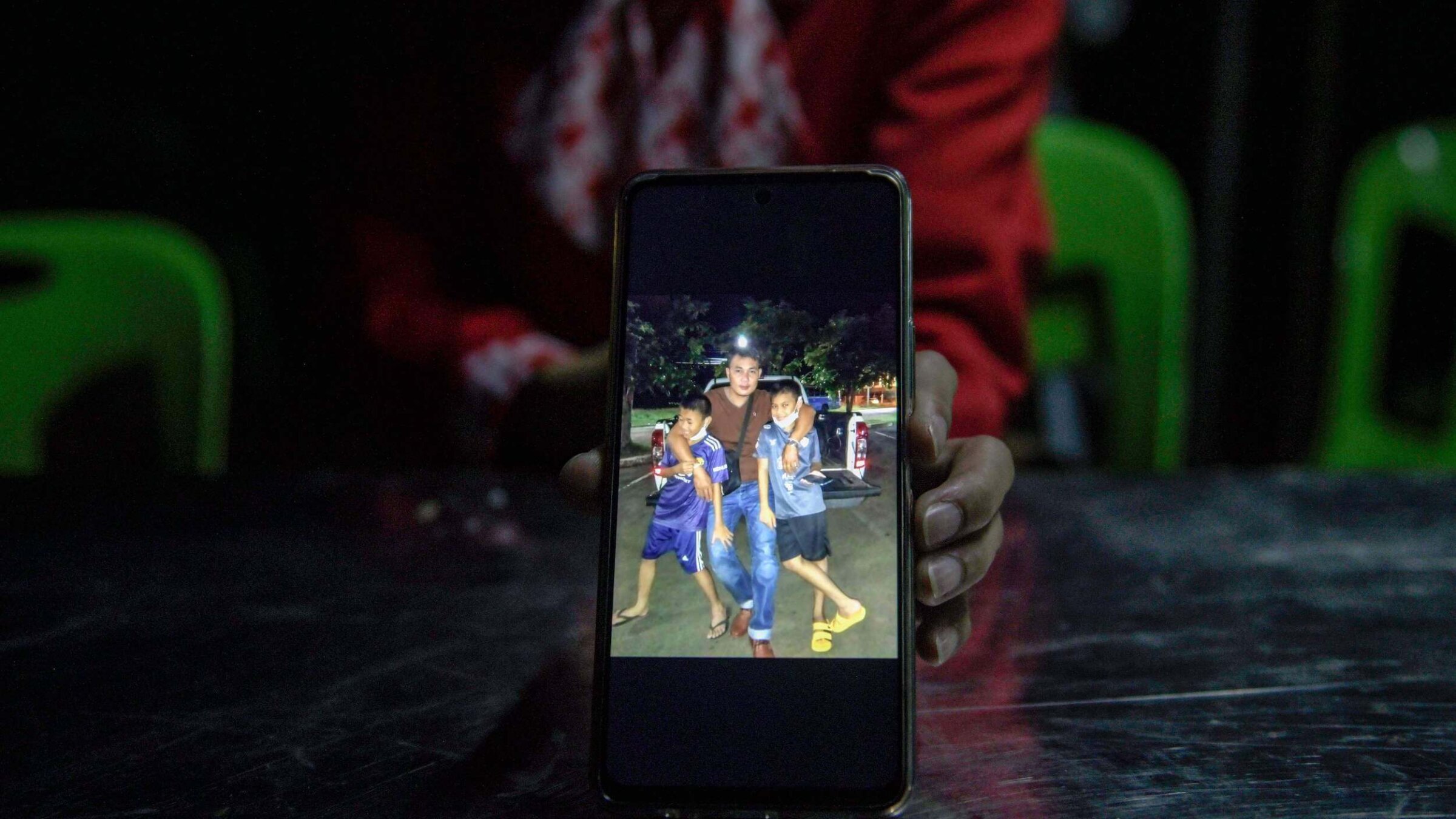 Kanyarat Suriyasri, the wife of Owat Suriyasri, a Thai worker who is being held hostage by Hamas in Gaza, shows a picture of him with their two children.