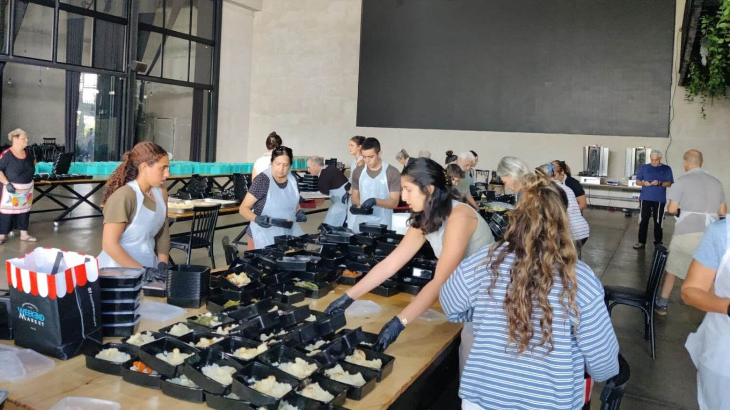 At her home in Moshav Avigdor in southern Israel, high school student Alma Tsach prepares meal kits for soldiers.