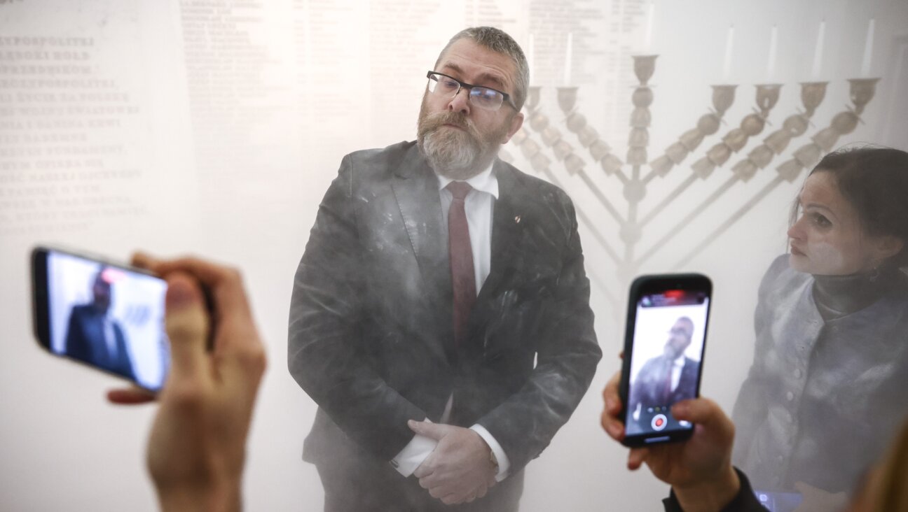 Grzegorz Braun seen shortly after using a fire extinguisher on a Hanukkah menorah in Poland’s parliament building in Warsaw, Dec. 12, 2023. (Beata Zawrzel/NurPhoto via Getty Images)