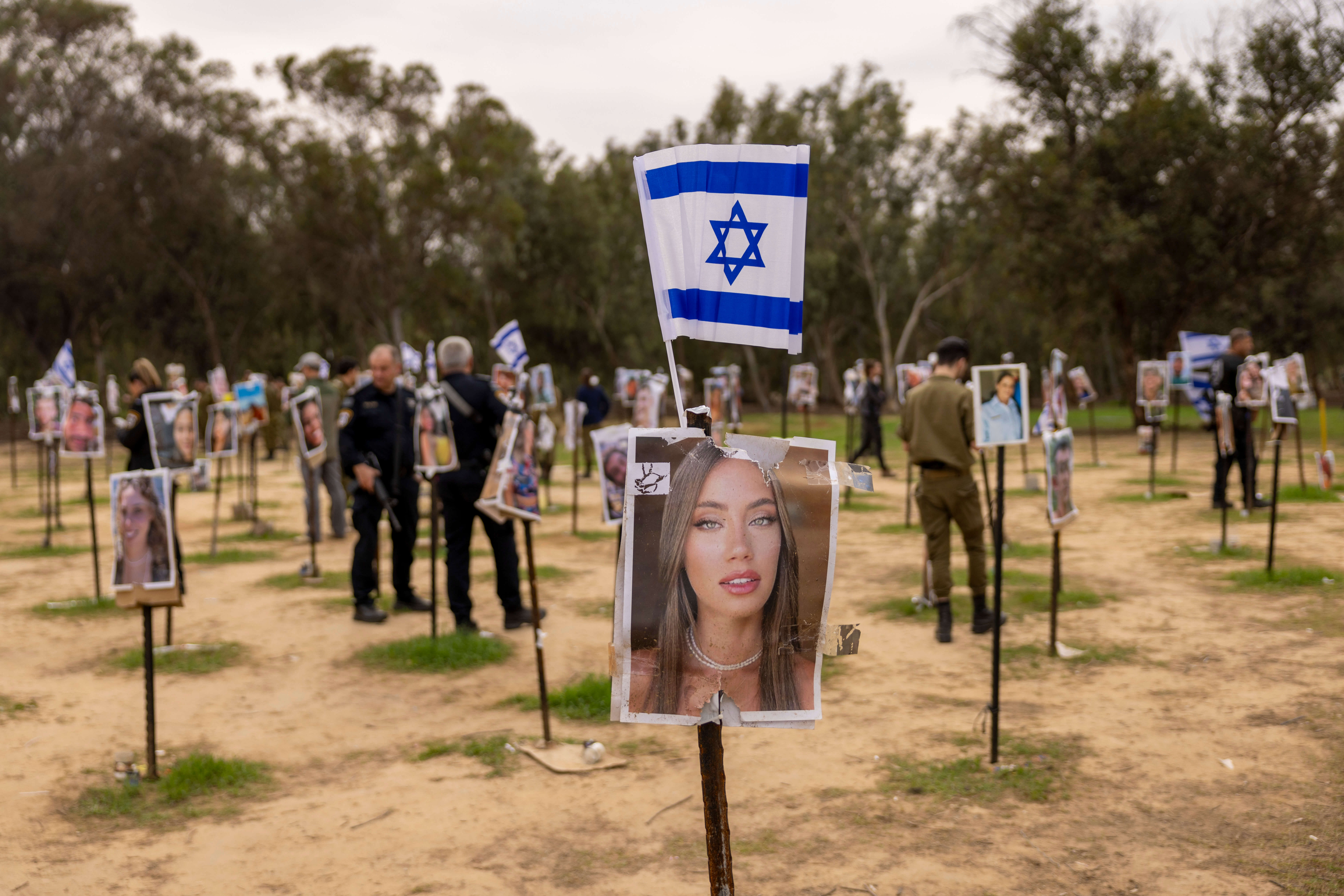 A display of photos of people killed during the Hamas attack at the Nova festival site in Re'im, Israel.