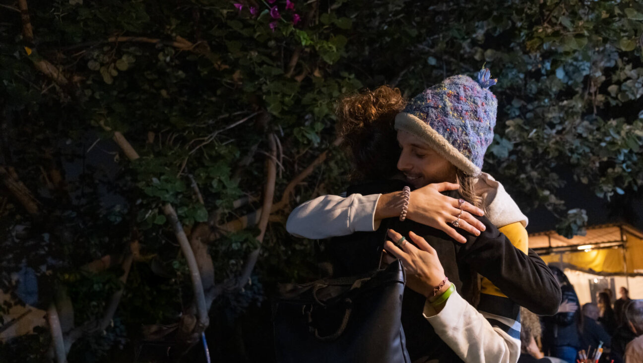 Survivors of the Nova Music Festival massacre embrace at Adama Tova.