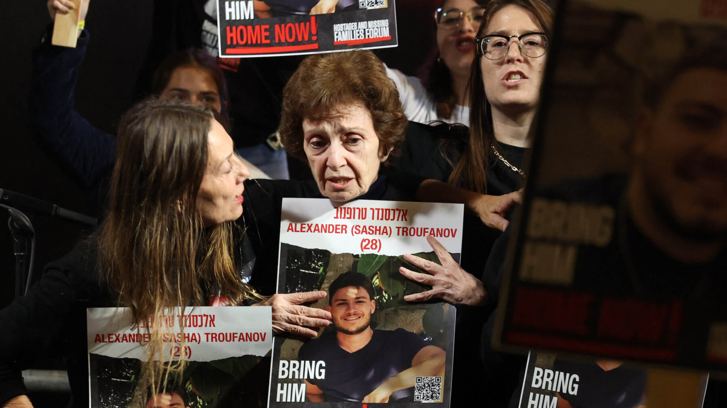 Irena Tati, a released Russian-Israeli hostage, holds a picture of her 27-year-old grandson  Alexander (Sasha) Trufanov during a Saturday night demonstration in Tel Aviv. 