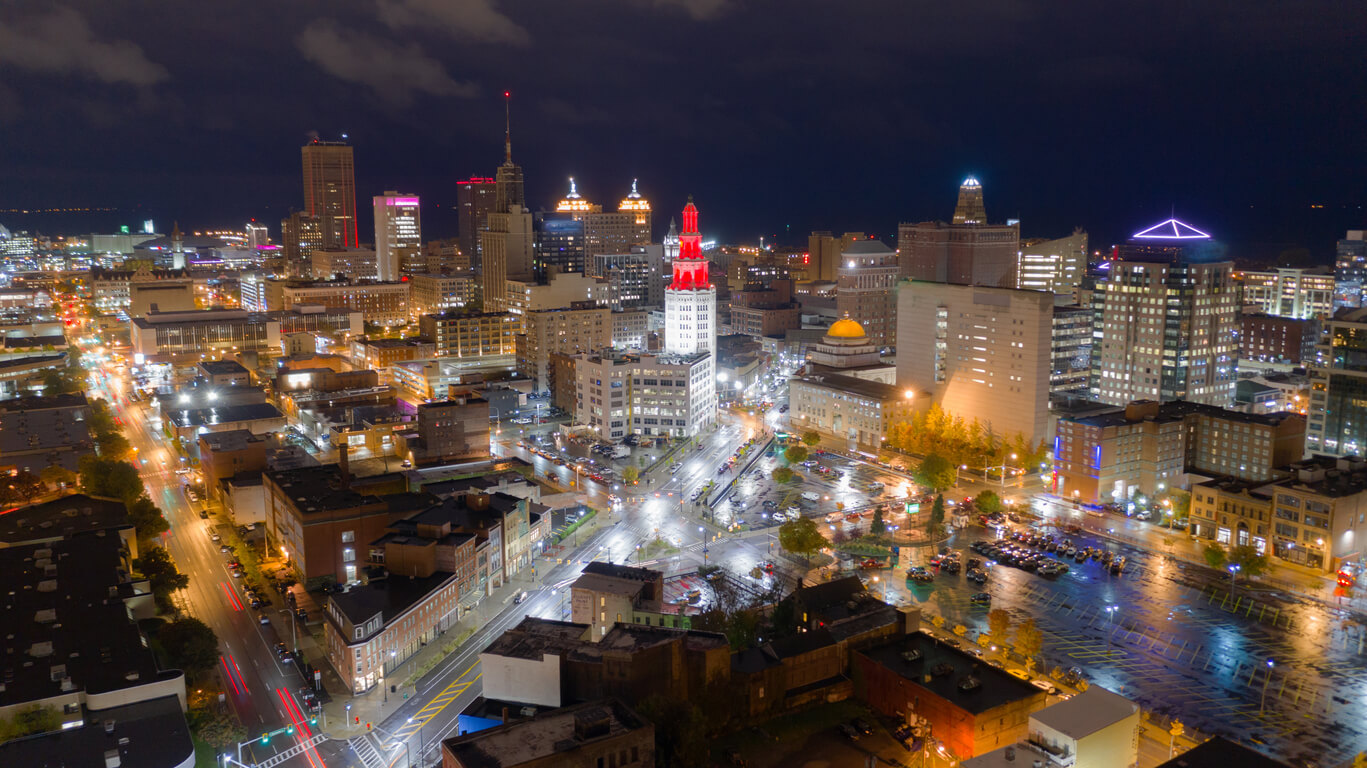 A view of buildings illuminated before sunrise in Buffalo.