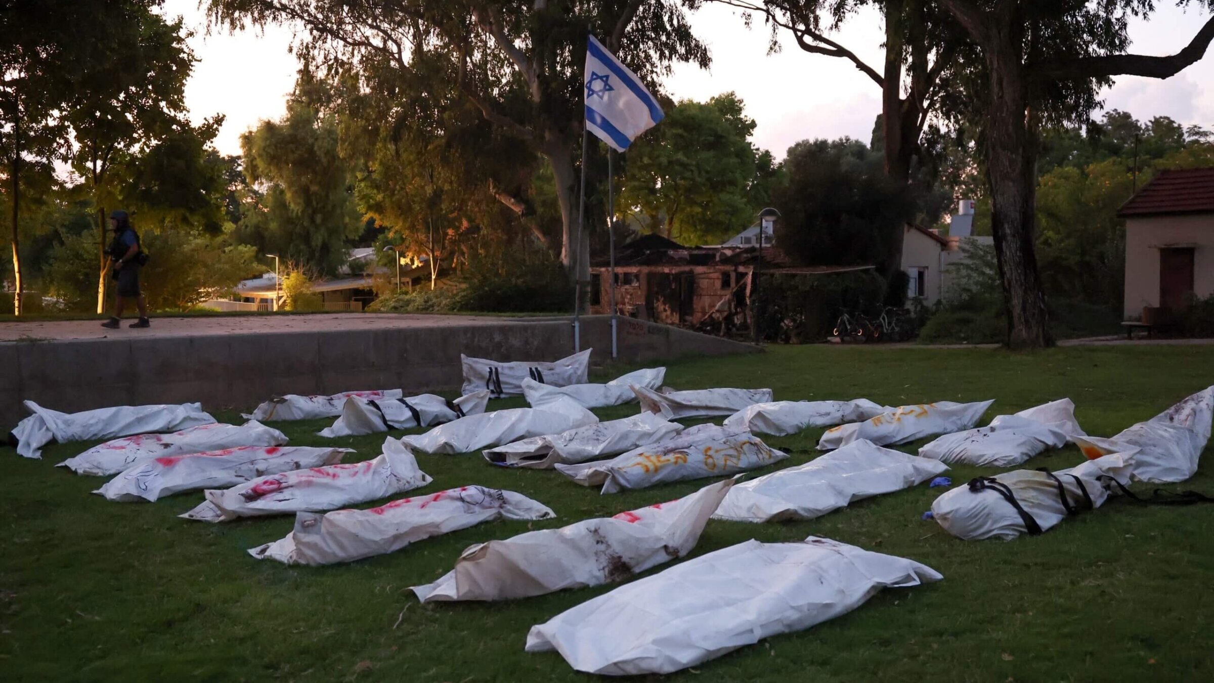 Covered bodies at Kibbutz Be'eri near the border with Gaza. Sahar Baruch was kidnapped and his brother murdered in a Hamas attack there. 