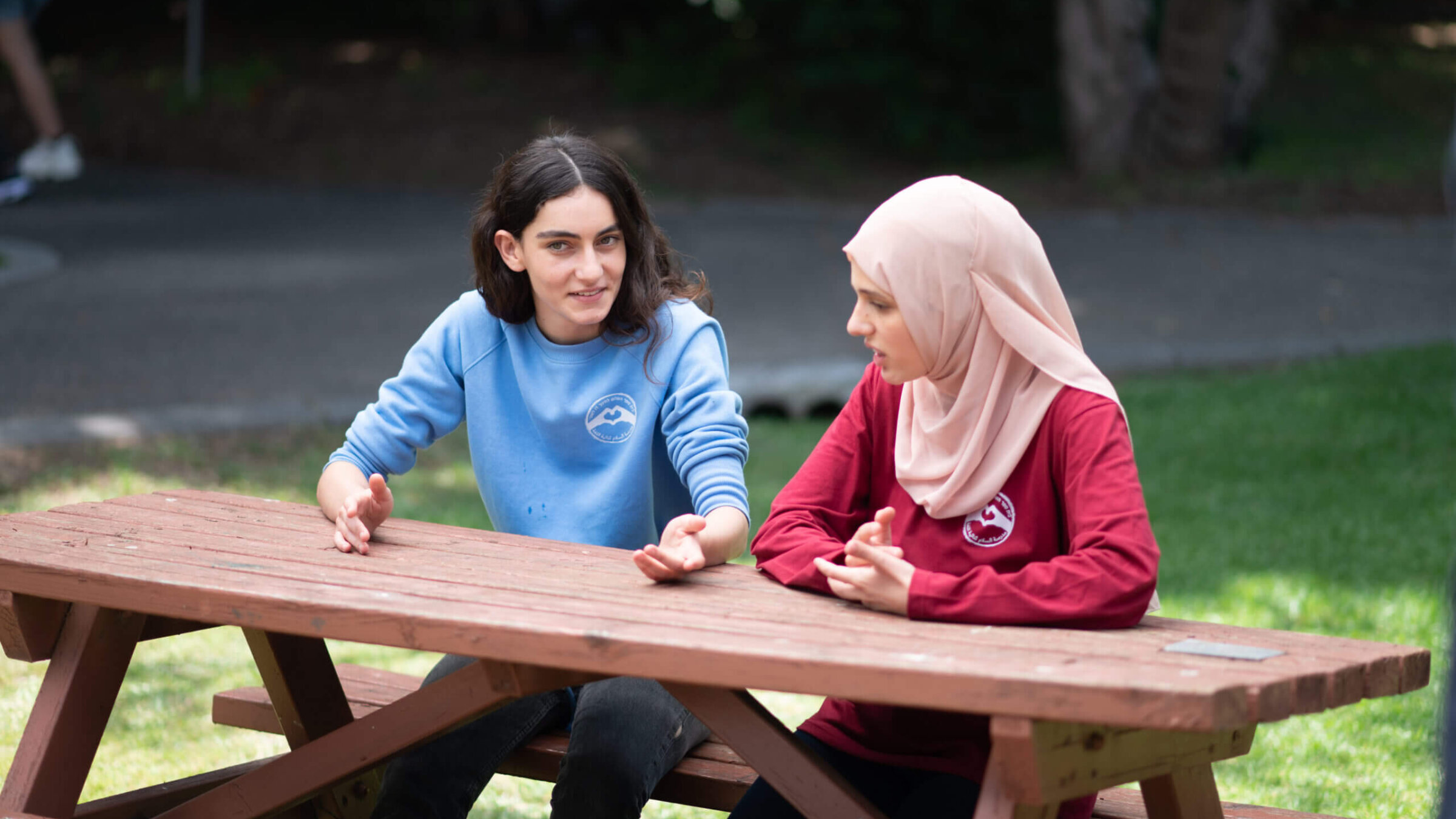 Shira, a Jewish student, and Lubna, an Arab student, are good friends.