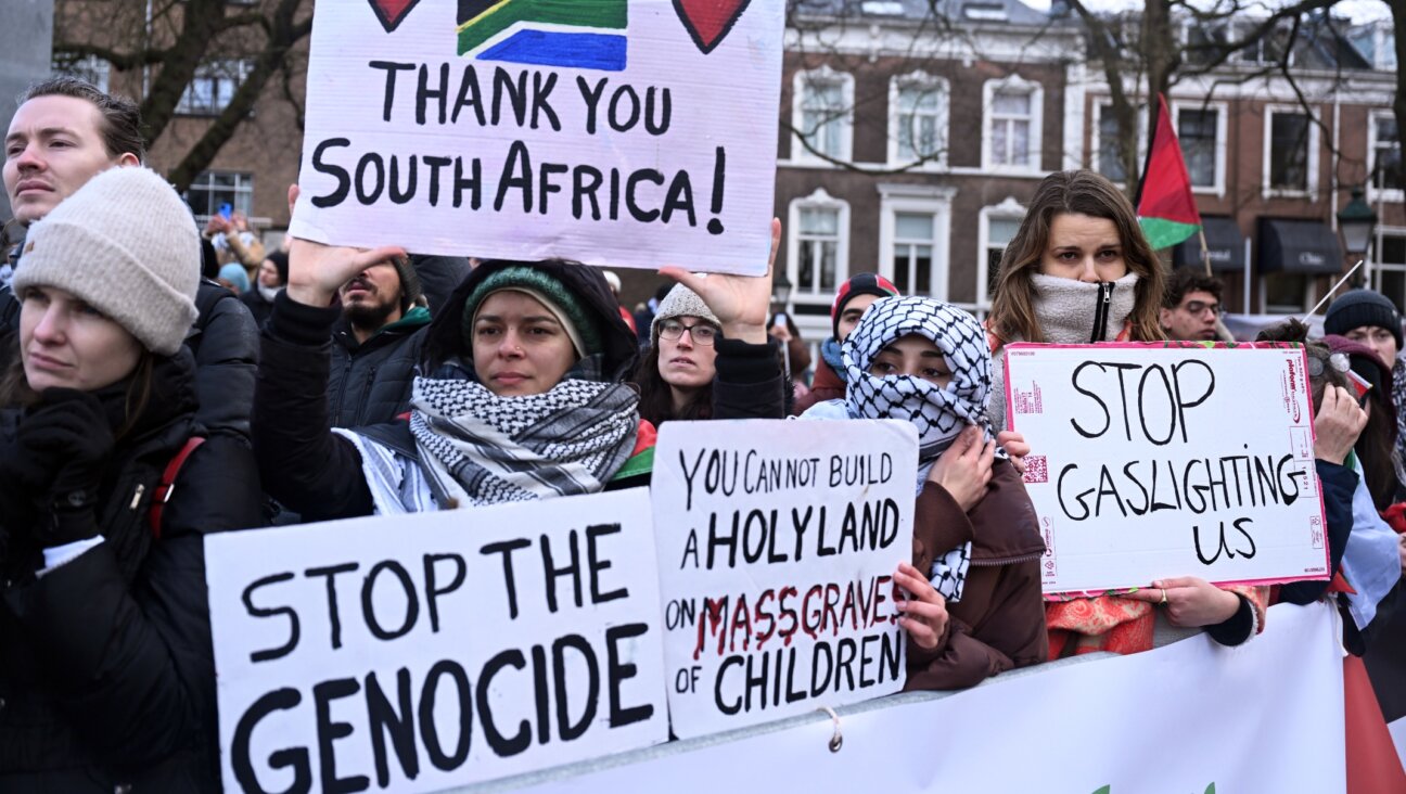 Pro-Palestinian supporters gather in front of the International Court of Justice building to demonstrate with Palestinian flags and banners during the hearing on the request for interim measures in the case filed by Israel at the ICJ on the grounds that Israel’s actions in Gaza violate the Genocide Convention in The Hague, Netherlands, Jan. 12, 2024. (Dursun Aydemir/Anadolu via Getty Images)