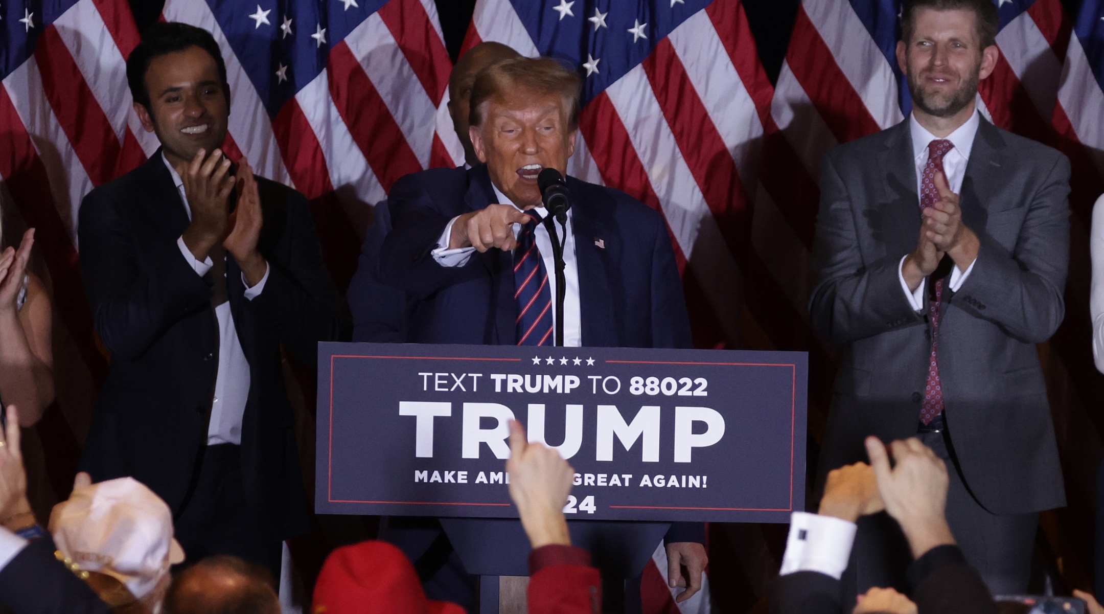 Republican presidential candidate and former U.S. President Donald Trump delivers remarks alongside supporters, campaign staff and family members during his primary night rally at the Sheraton in Nashua, New Hampshire, Jan. 23, 2024. (Alex Wong/Getty Images)