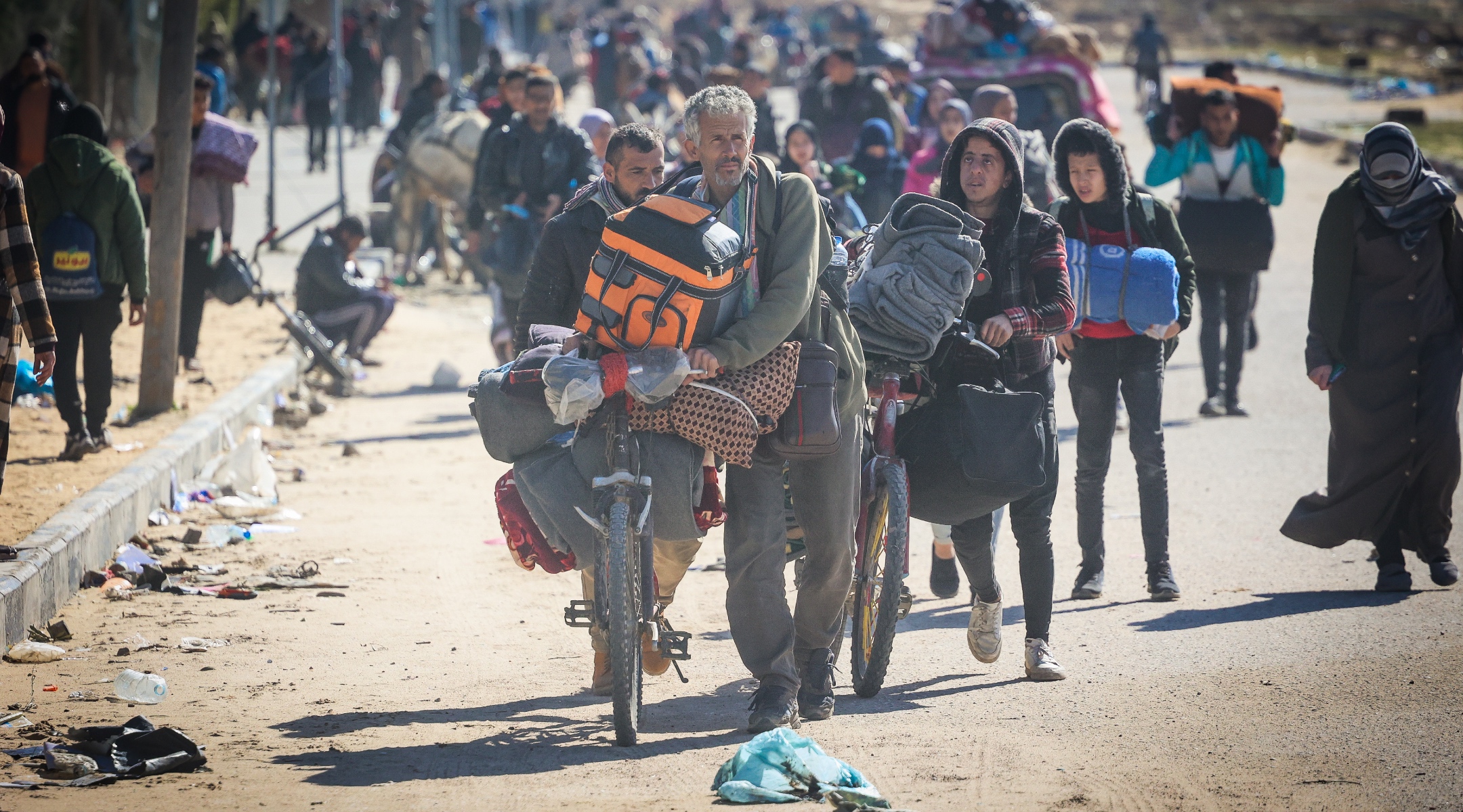 Israeli tanks secure the area while Palestinians fleeing from the fighting parts of Khan Yunis to Rafah, in the southern Gaza Strip, Jan. 30, 2024. (Atia Mohammed/Flash90)