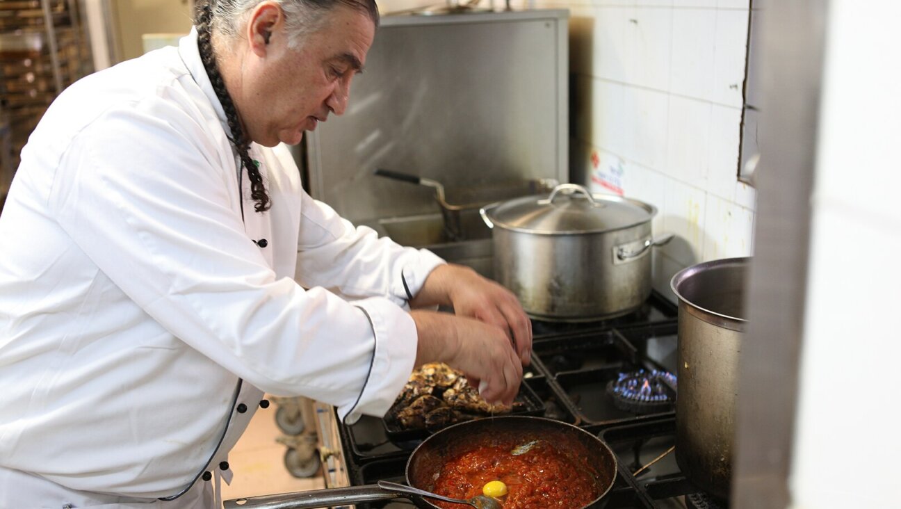 Chef Moshe Basson preparing shakshuka at his Eucalyptus restaurant in Jerusalem.