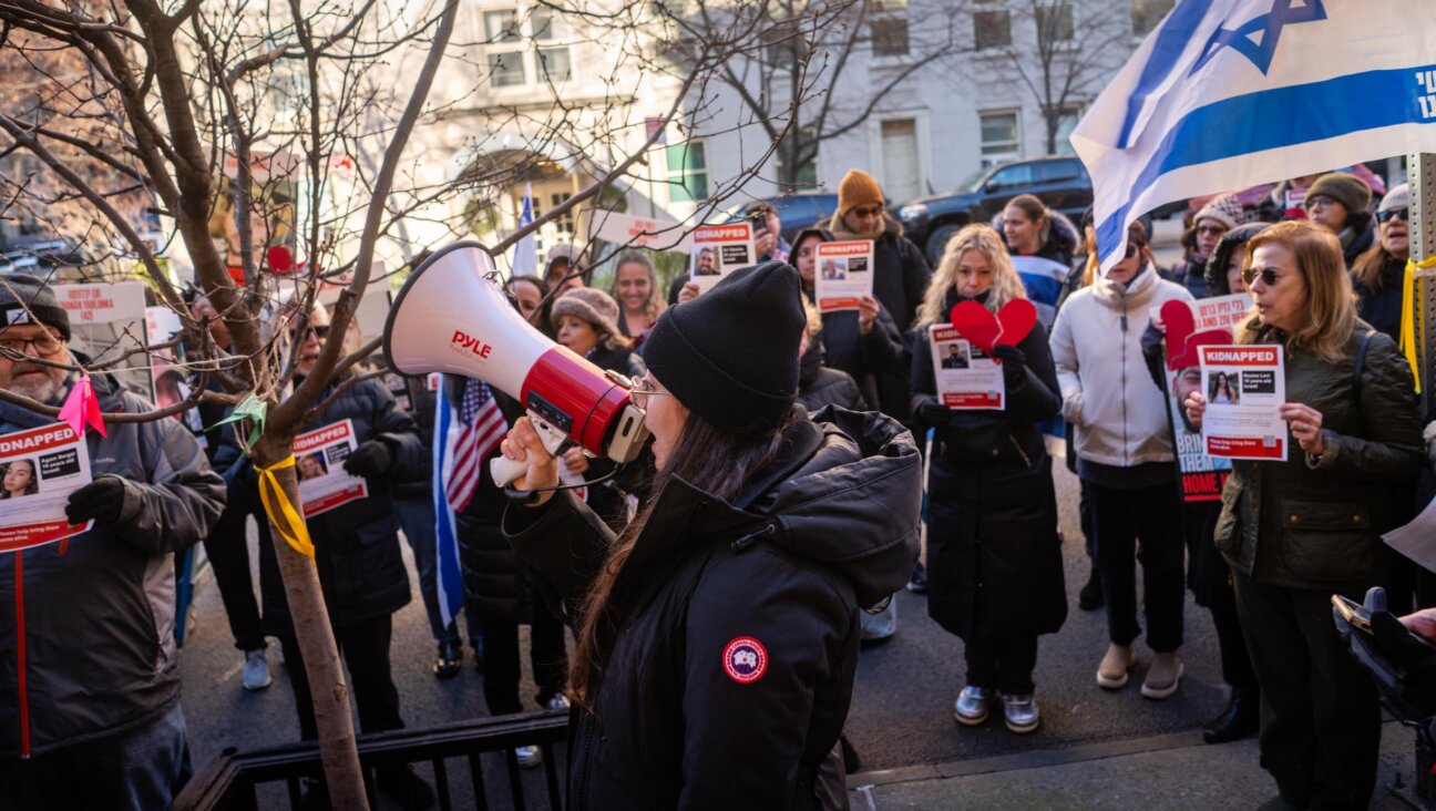 Protest leader Shany Granot-Lubaton leads a crowd outside the home of U.N. Secretary-General Antonio Guterres, January 5, 2024. (Luke Tress)