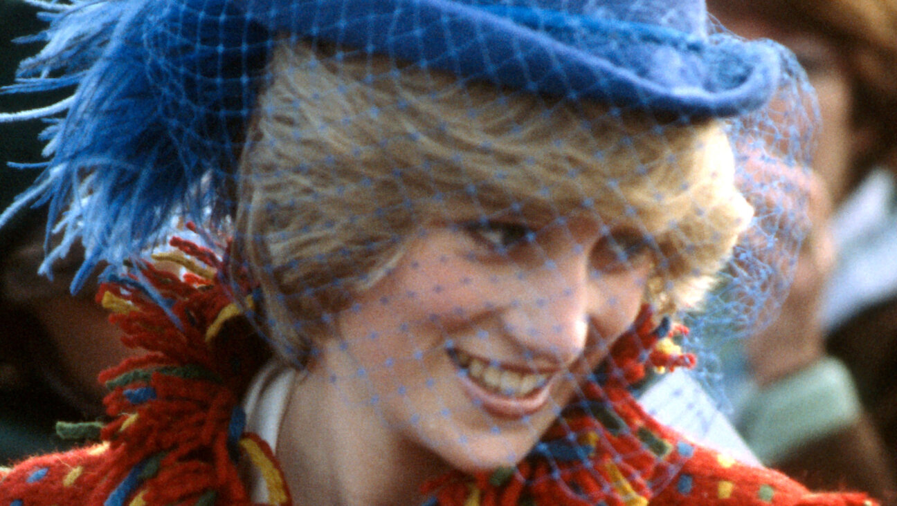 Princess Diana, circa 1982, wearing a red coat designed by Bellville Sassoon and a John Boyd hat.