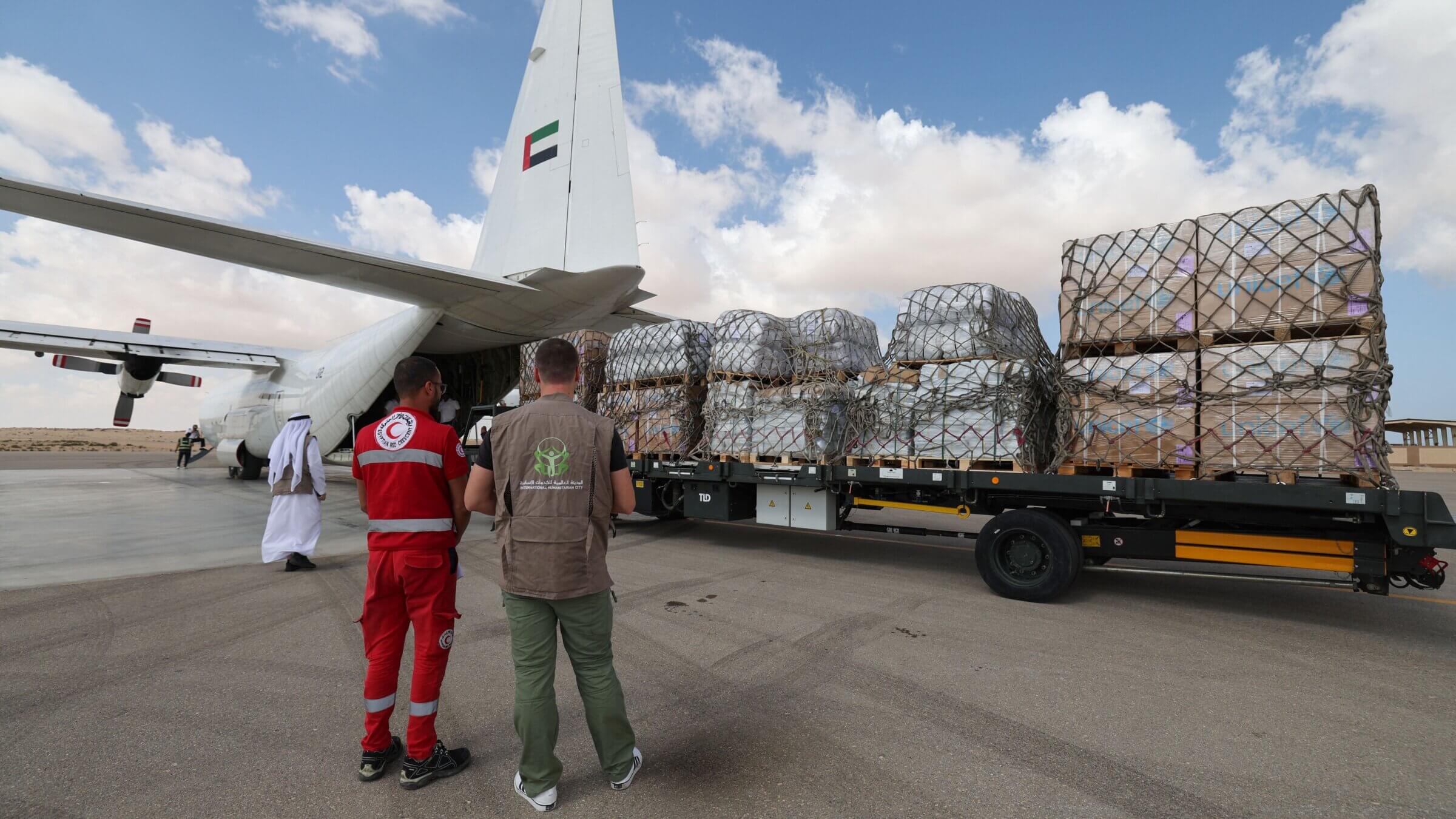 Staff members unload aid for the Gaza Strip from an Emirates cargo plane on the tarmac of Egypt's el-Arish airport in the north Sinai Peninsula on Oct. 19.