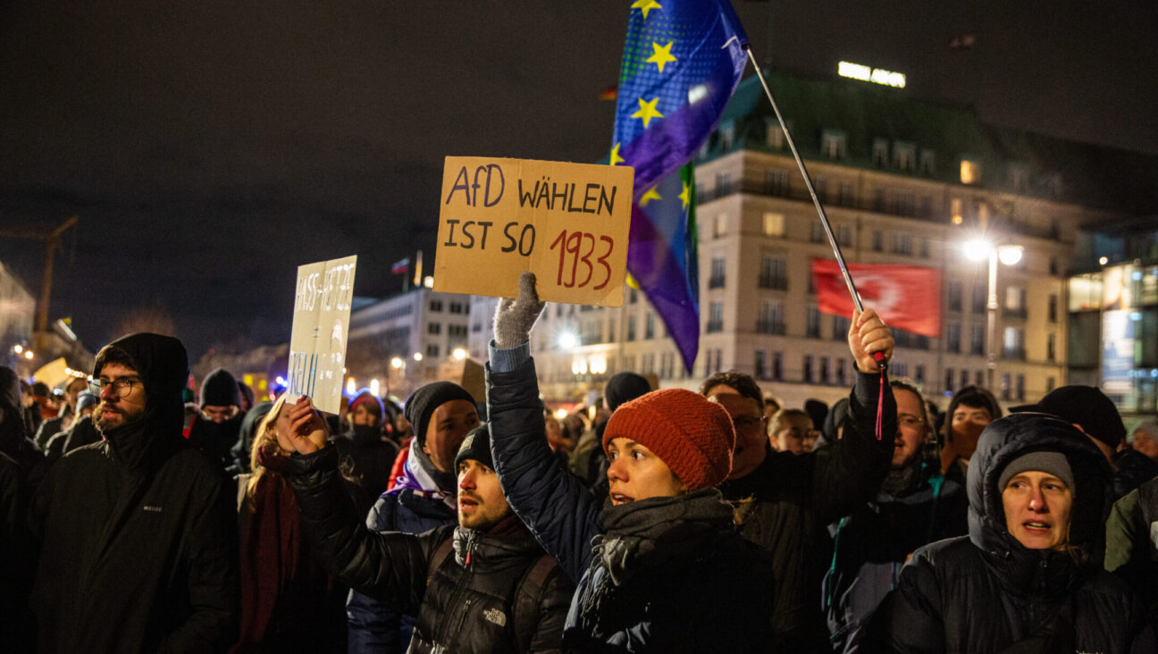 A rally against far-right extremism in Berlin featured signs connecting the plans of a far-right party, AfD, to the plotting of the Nazis against the Jews, Jan. 21, 2024. (Hami Roshan/Middle East Images/AFP via Getty Images)