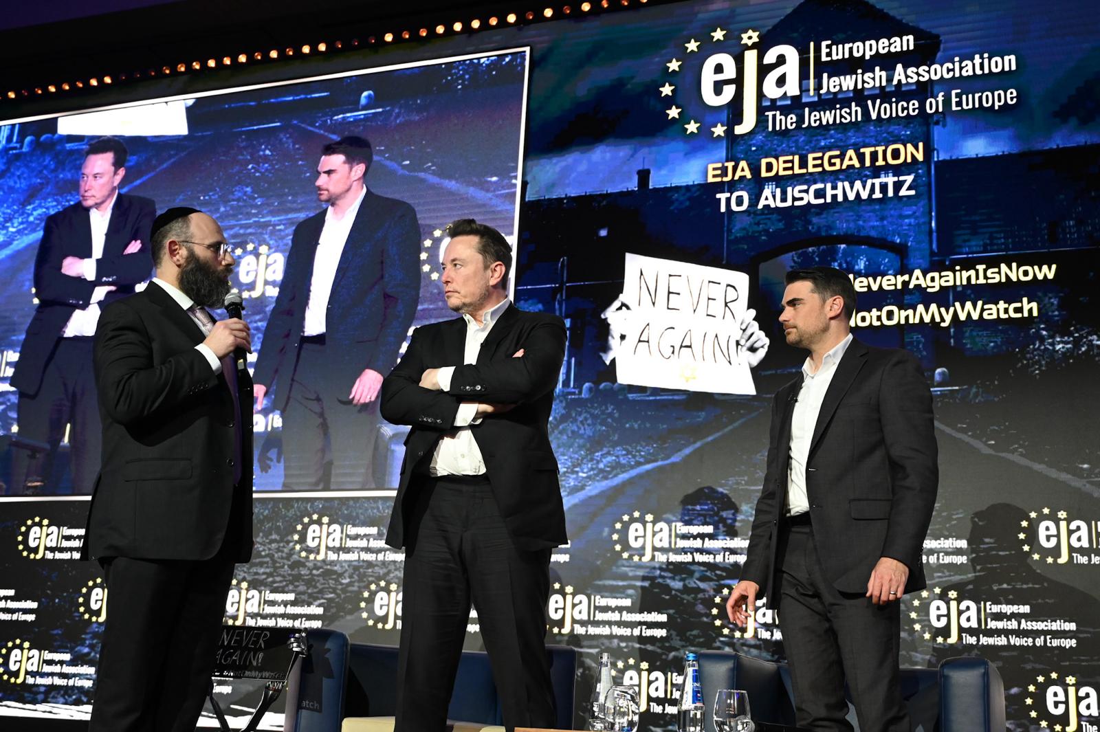 Rabbi Menachem Margolin of the European Jewish Association, Elon Musk and right-wing pundit Ben Shapiro stand on stage at an EJA conference in Krakow, Poland, Jan. 22, 2024. (Courtesy EJA)