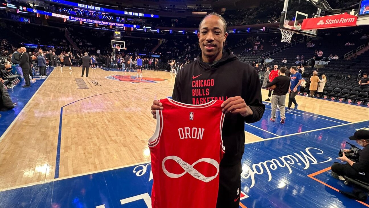 DeMar DeRozan displays the jersey he signed at Madison Square Garden.