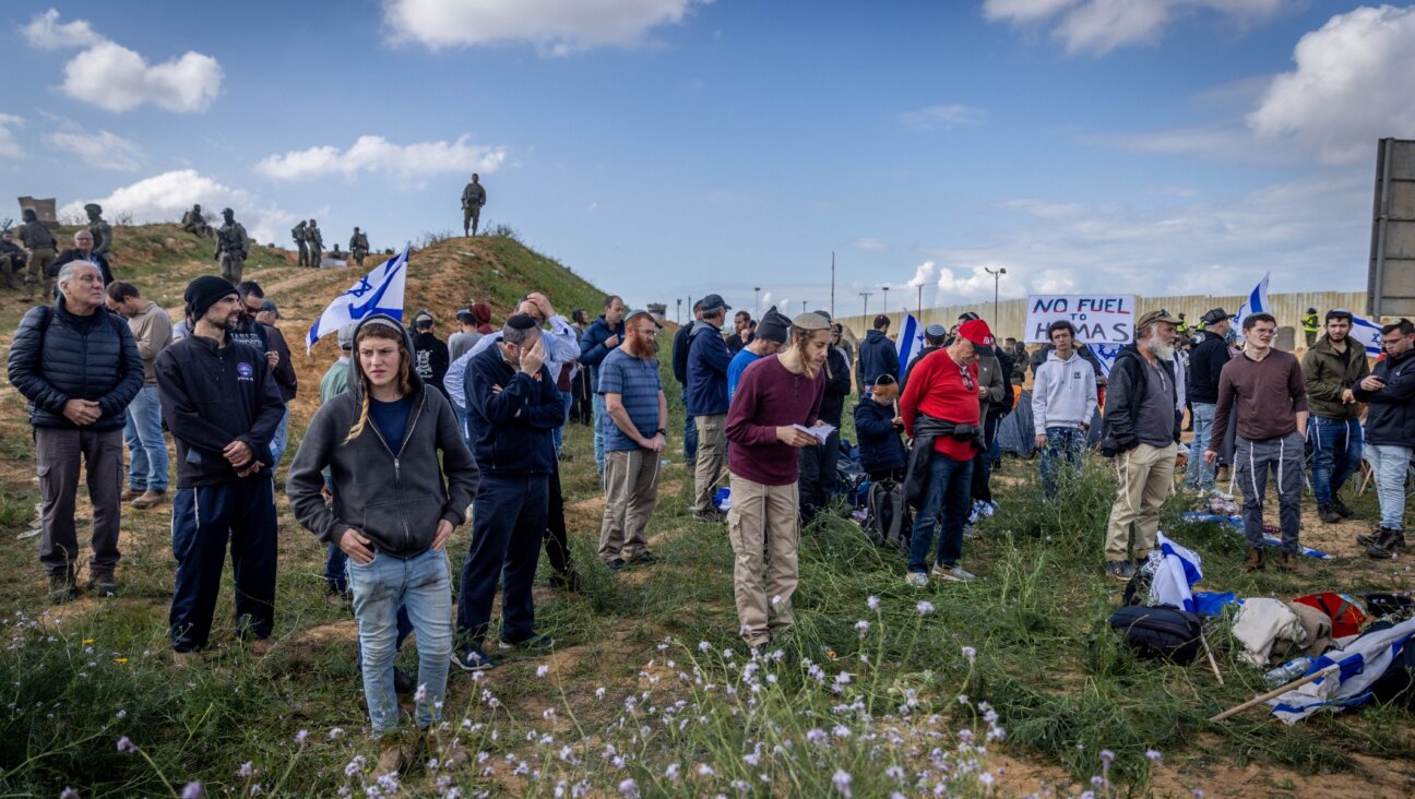 Israeli security forces guard while people protest against aid trucks entering the Gaza Strip, at the Kerem Shalom crossing in southern Israel, Jan. 29, 2024. (Chaim Goldberg/Flash90)