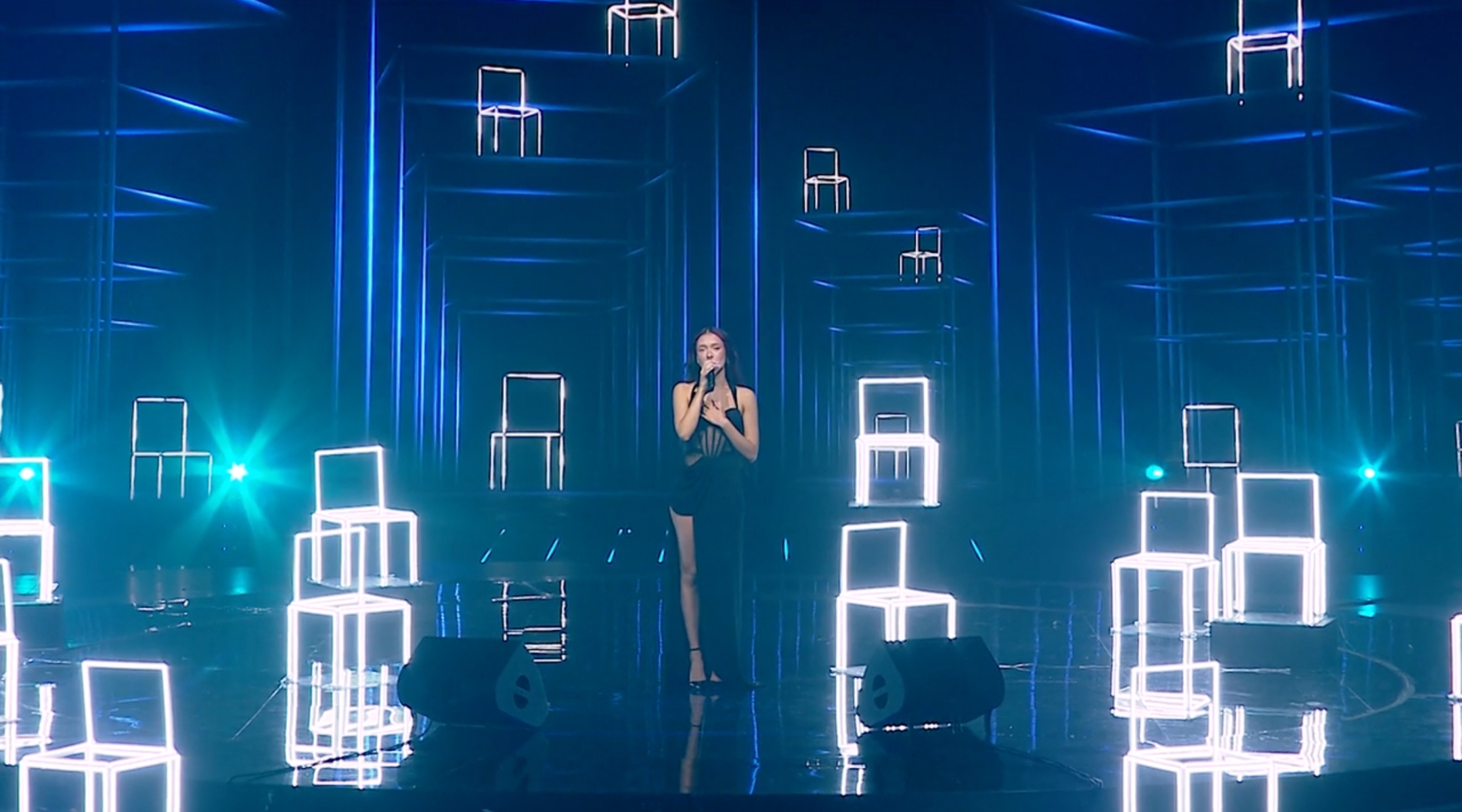 Eden Golan performs an emotional rendition of Aerosmith’s “I Don’t Want to Miss a Thing,” surrounded by empty chairs representing the missing hostages, for her grand finale performance to represent Israel in the 2024 Eurovision Song Contest. (Screenshot via Mako.co.il)